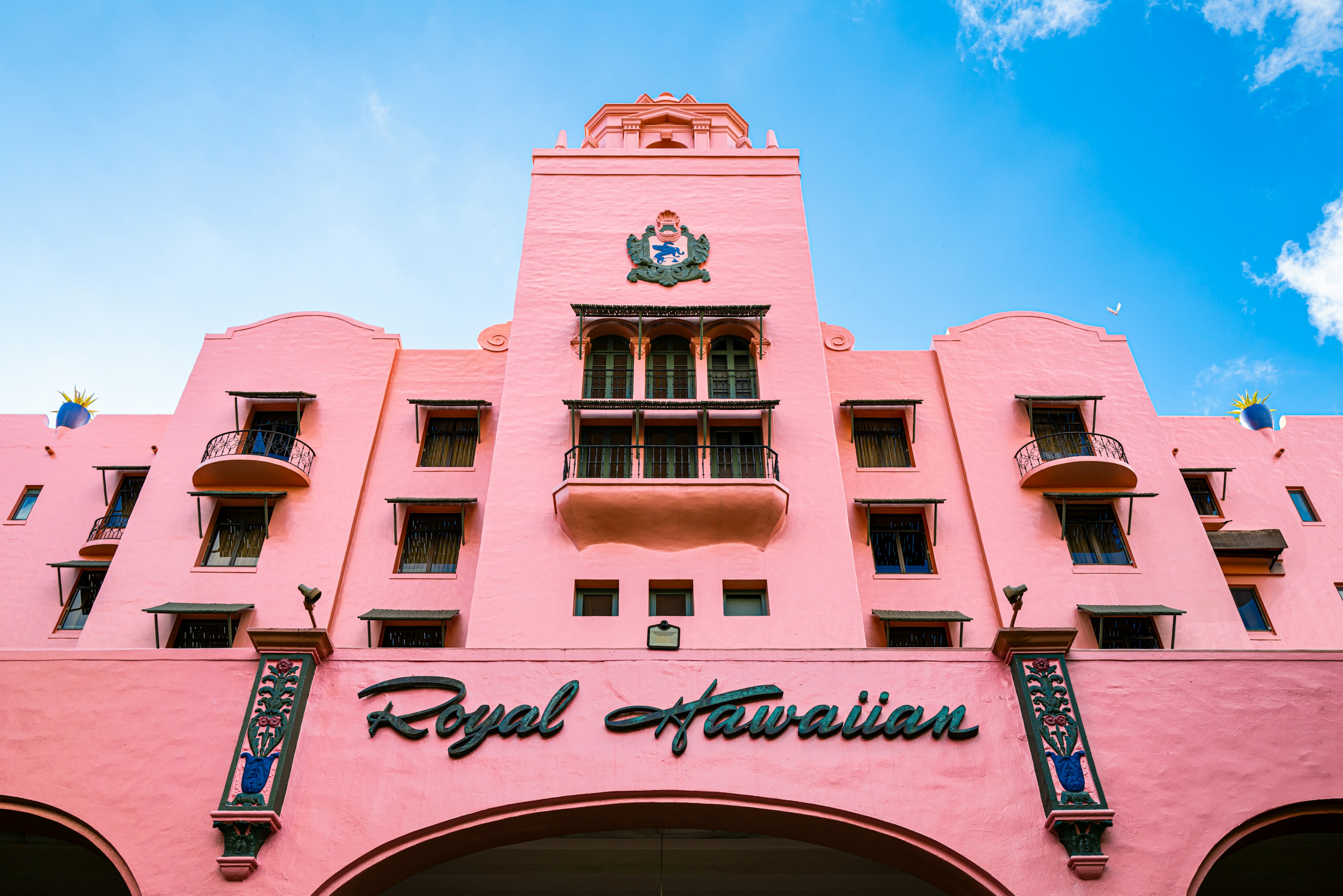 Royal Hawaiian Hotel with pink facade and blue sky