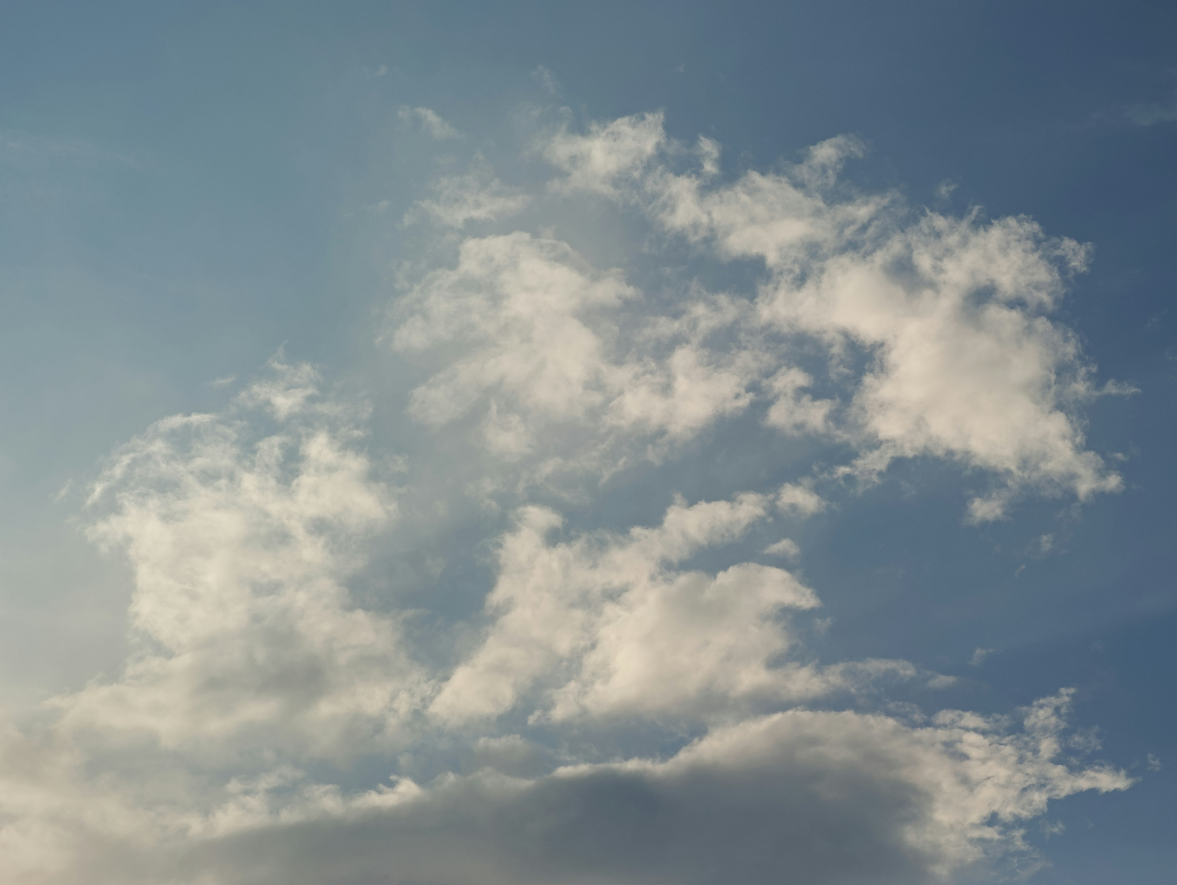 Pattern of white clouds in a blue sky