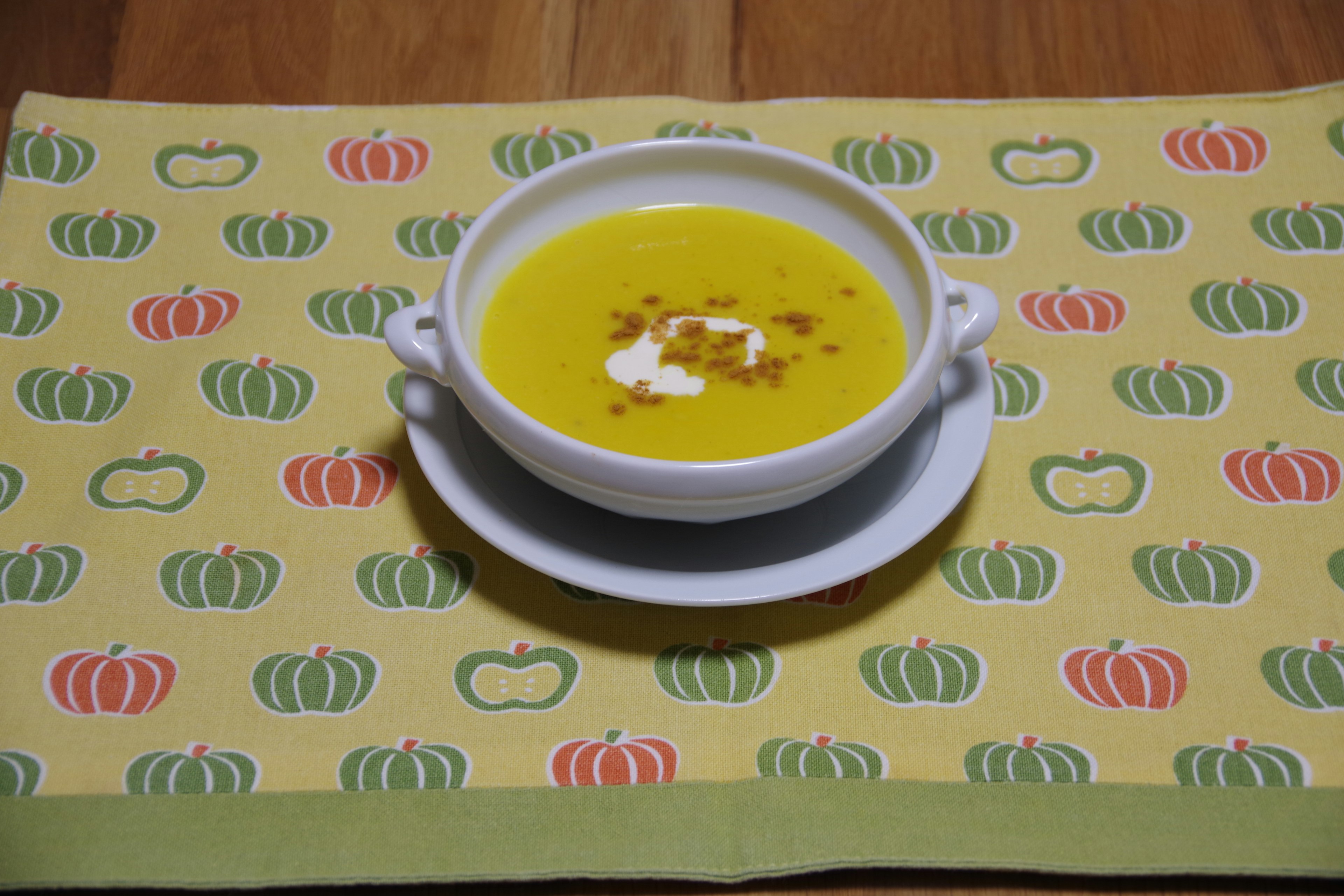 Creamy yellow soup served in a white bowl