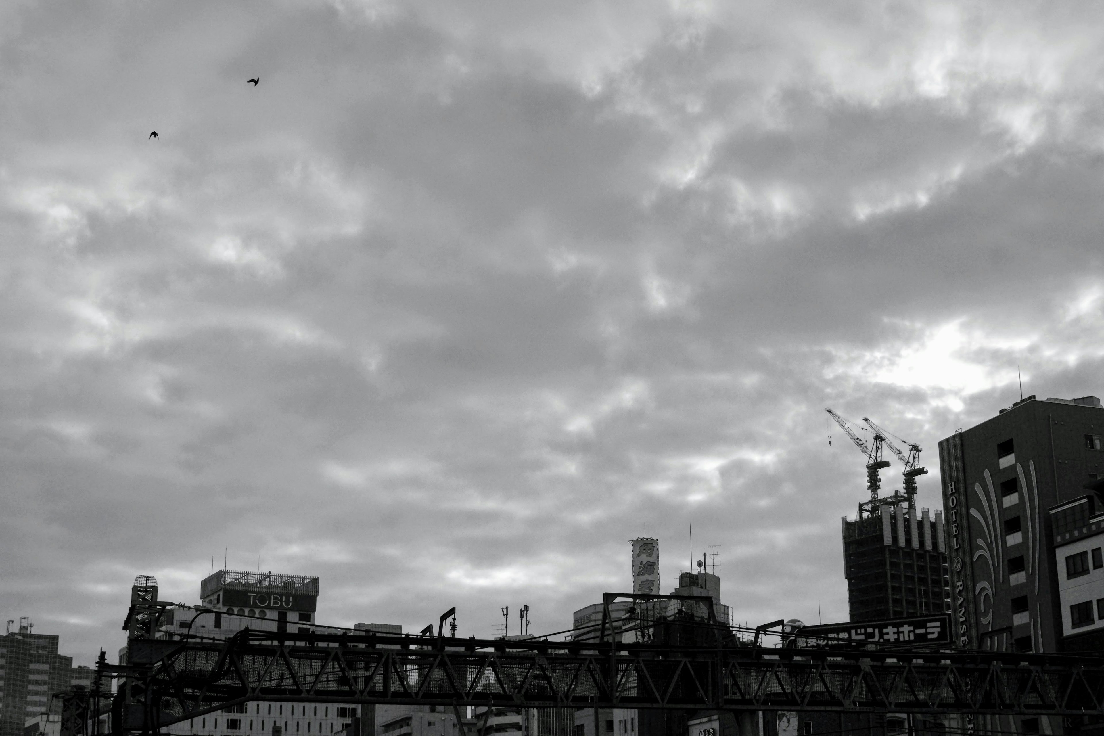 Gray clouds covering the sky with silhouettes of buildings