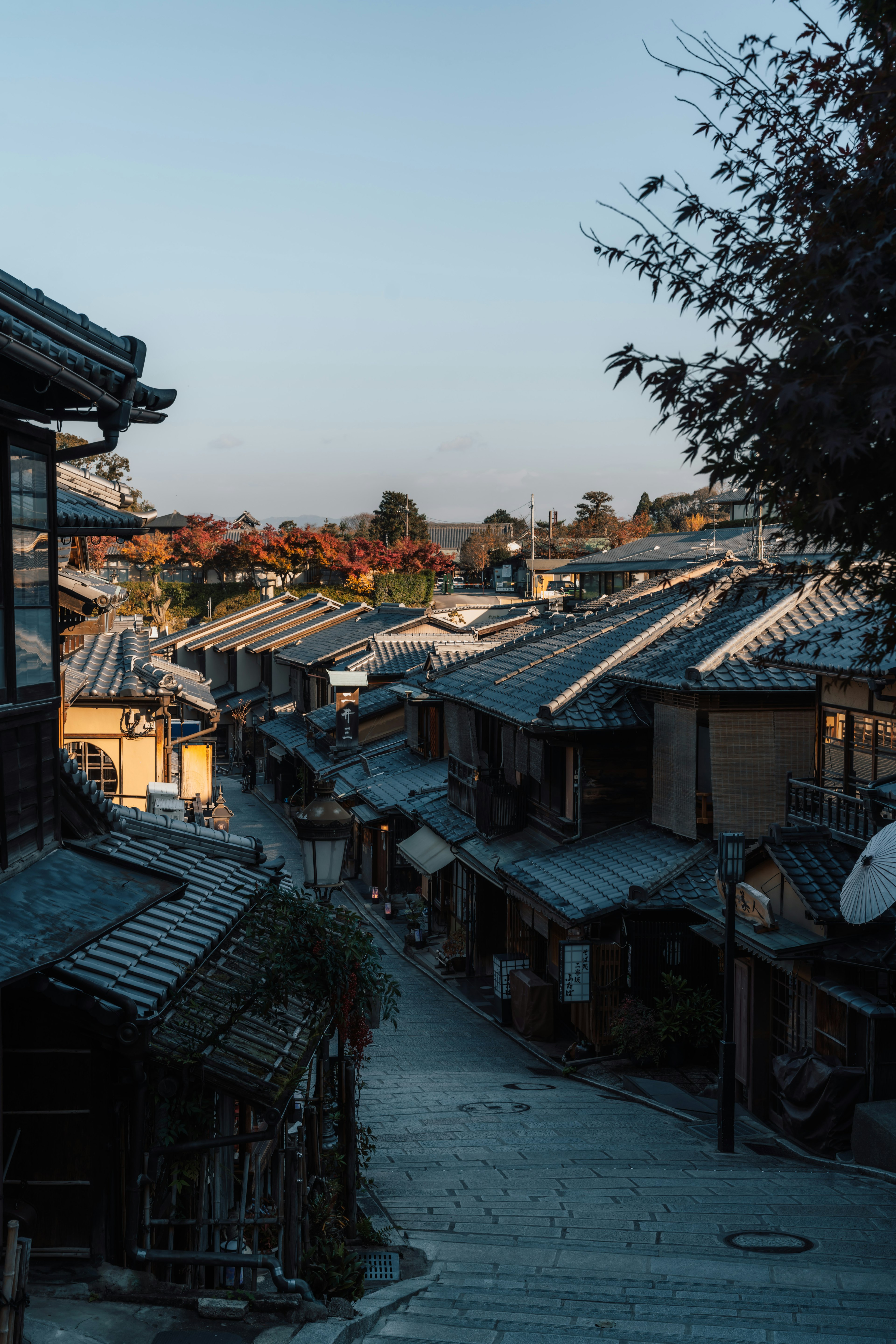 Quiet street with traditional Japanese houses illuminated by sunset