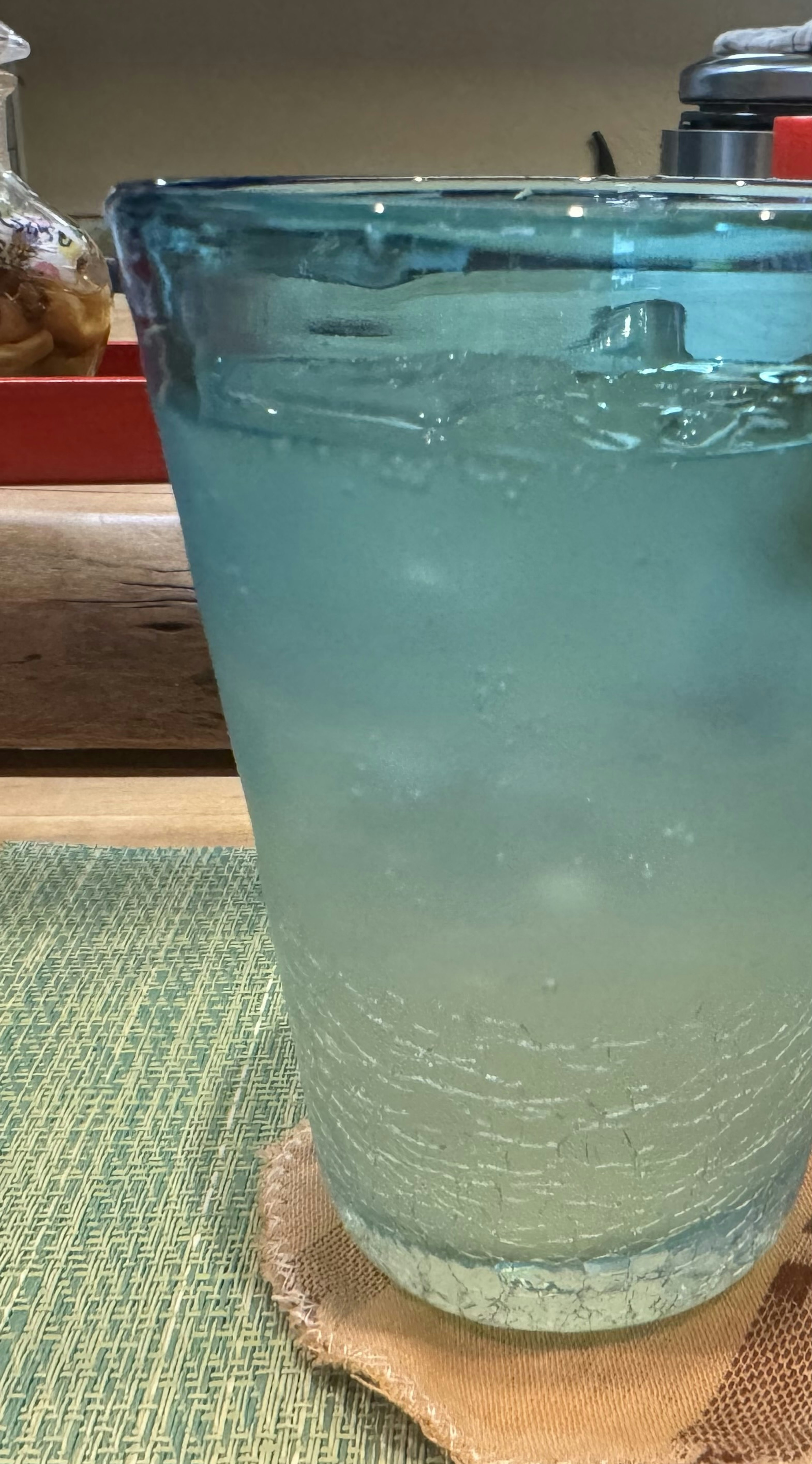 A glass of carbonated water in a blue glass