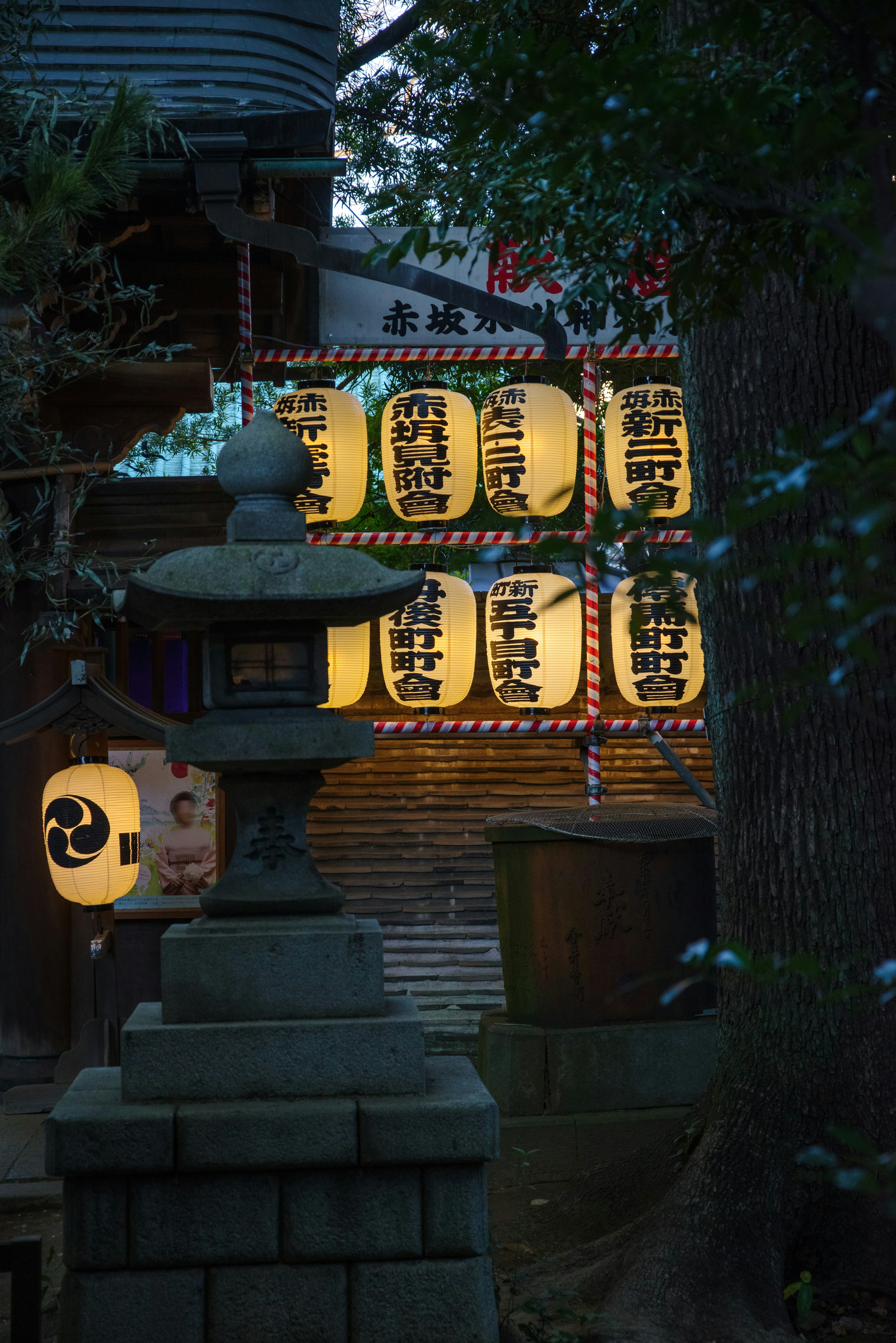 Night scene featuring traditional Japanese lanterns and stone lantern