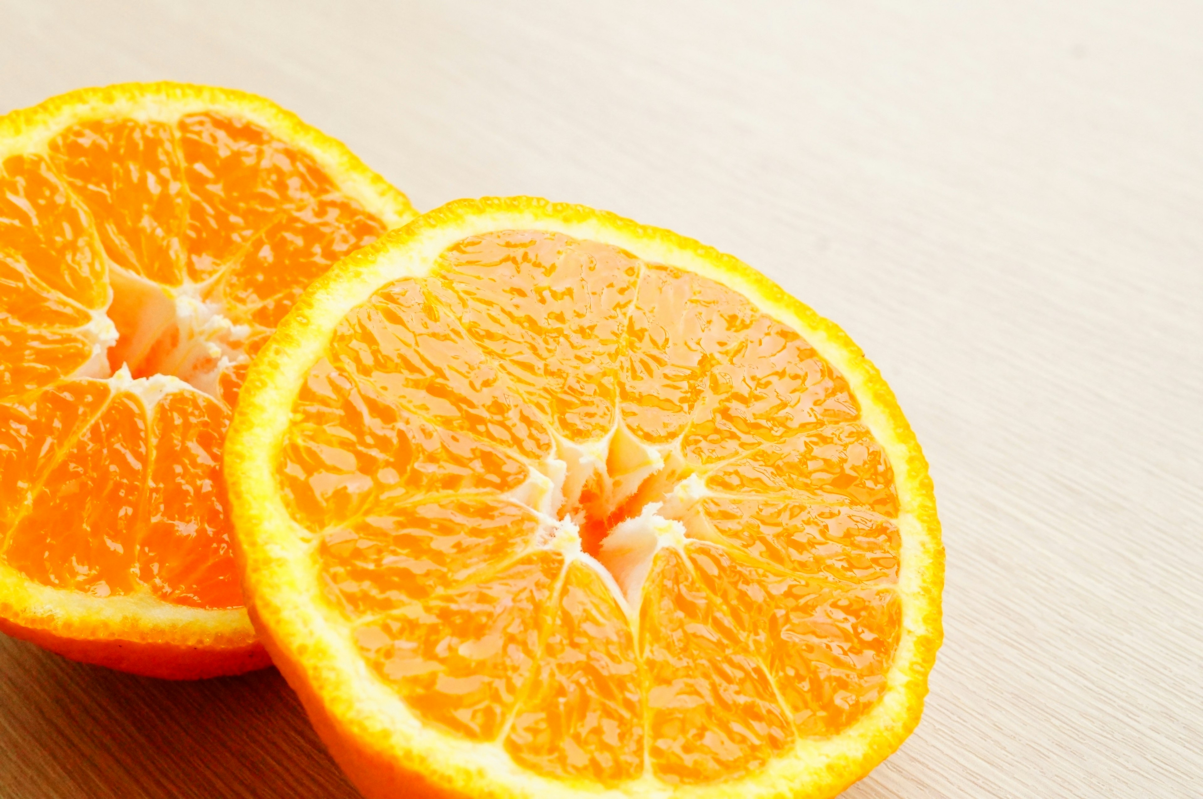 Half of an orange placed on a wooden table