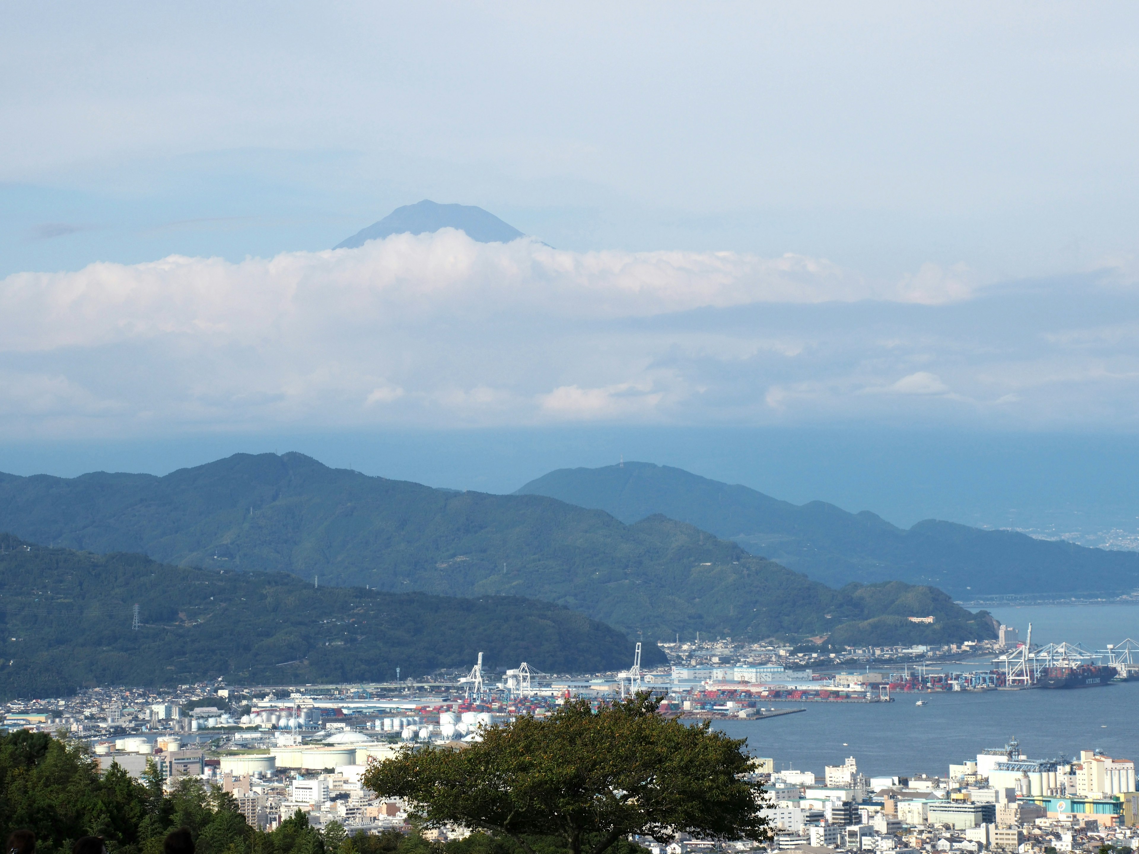 Coastal view of Shizuoka with Mount Fuji partially hidden by clouds