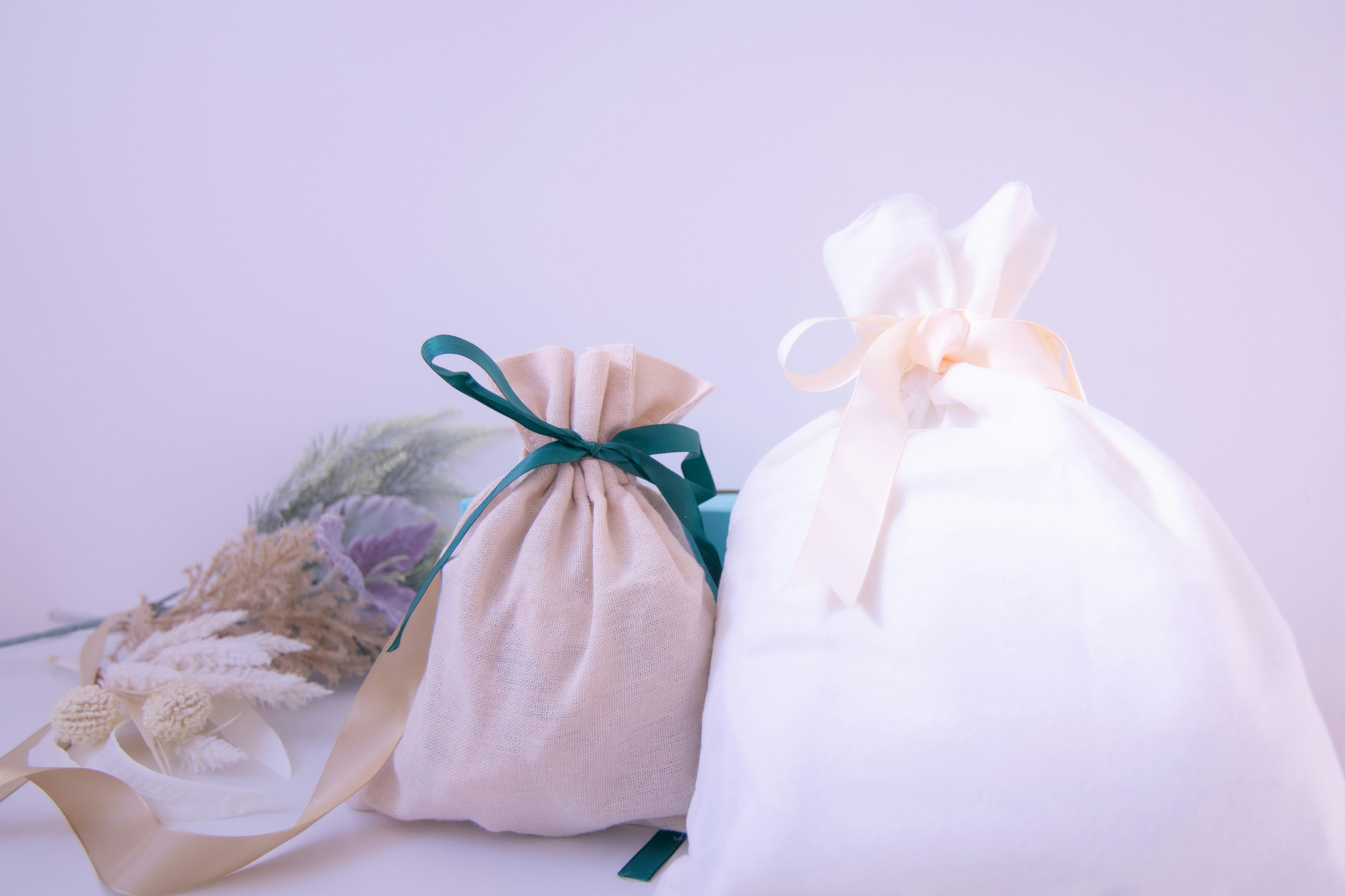 White and cream fabric bags tied with ribbons