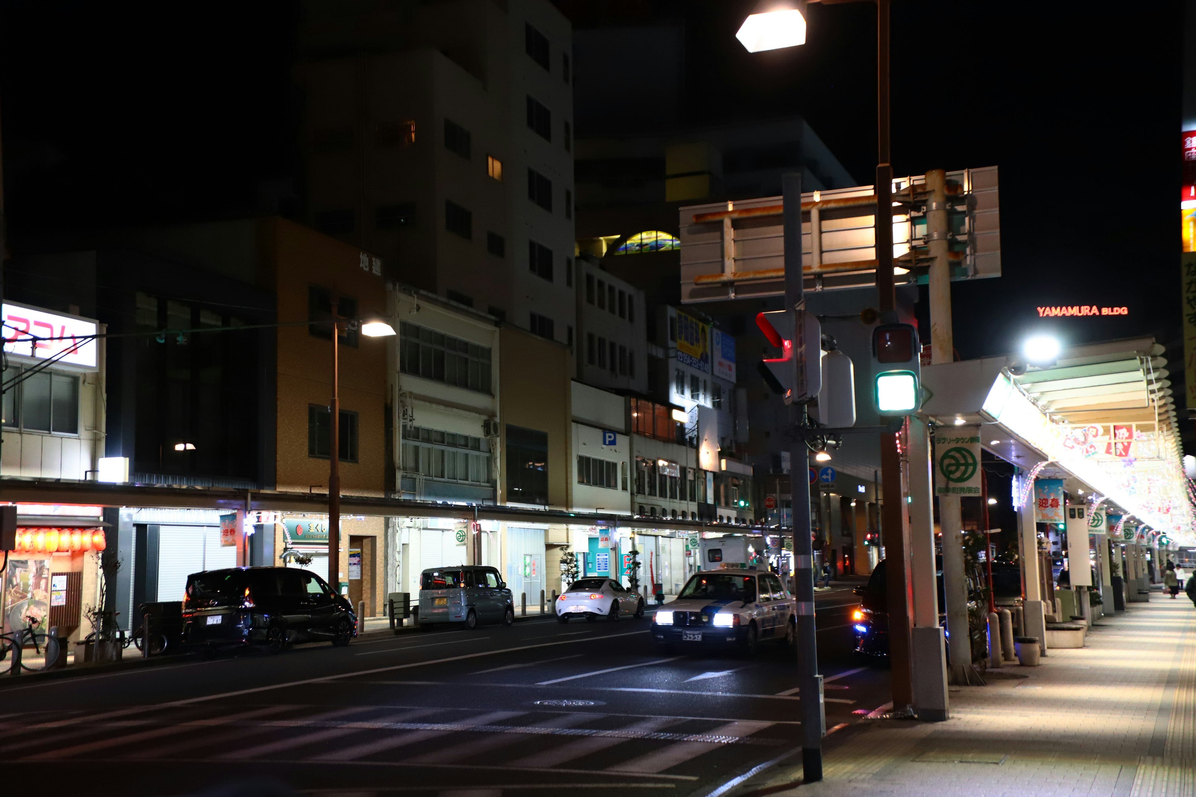 Night view of a city street with passing cars