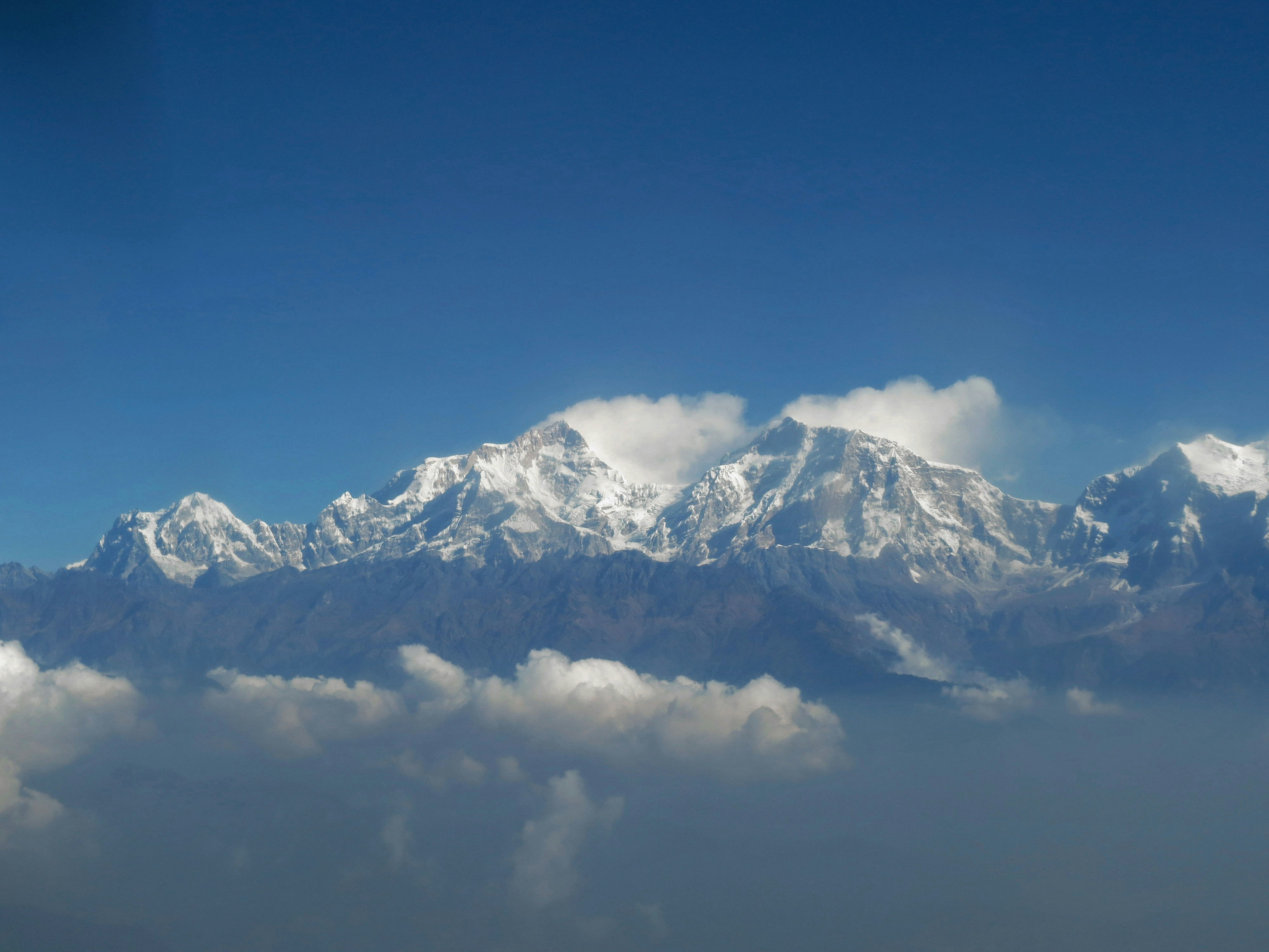 Snow-covered mountains under a clear blue sky