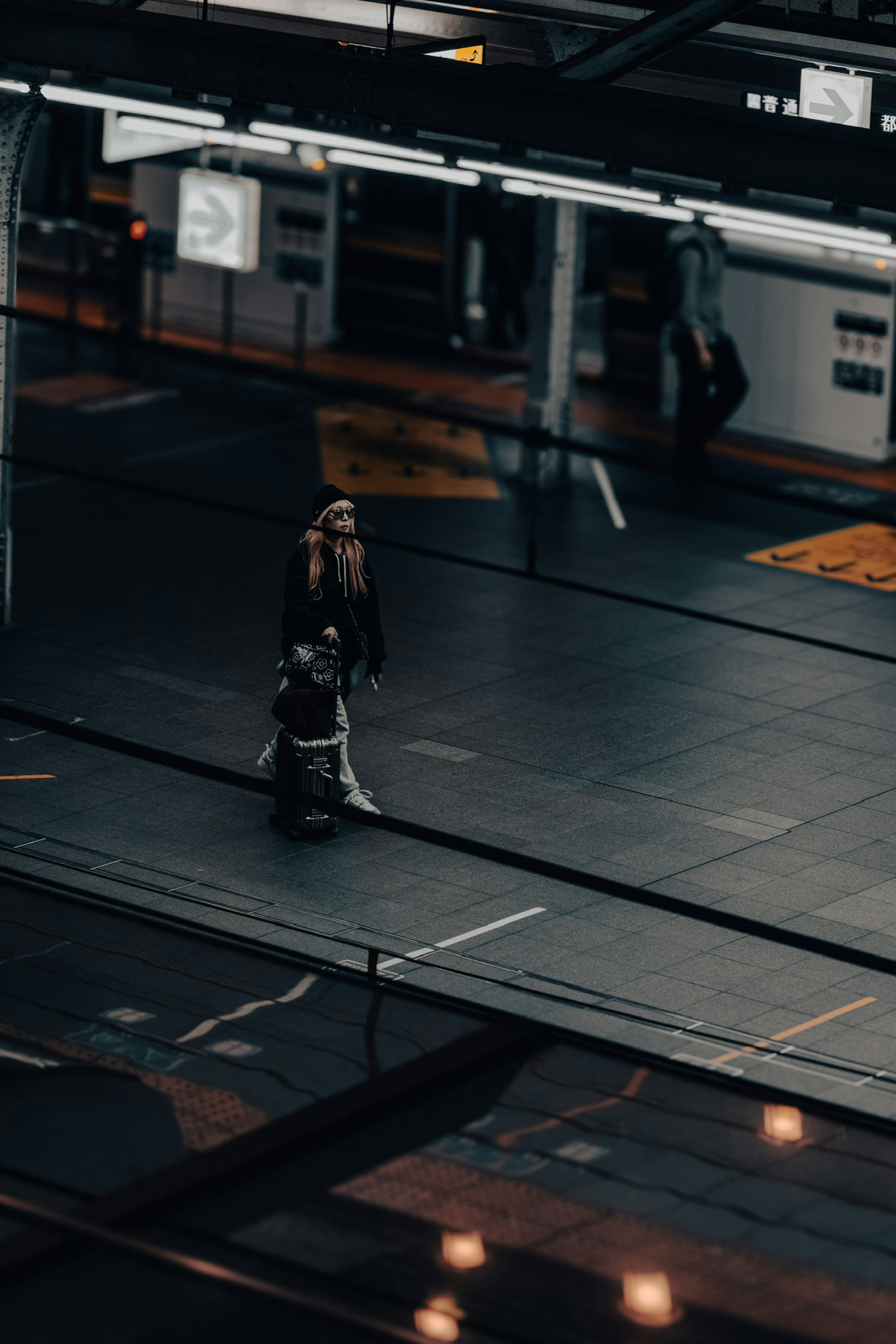 Silhouette of a person with luggage on a train platform