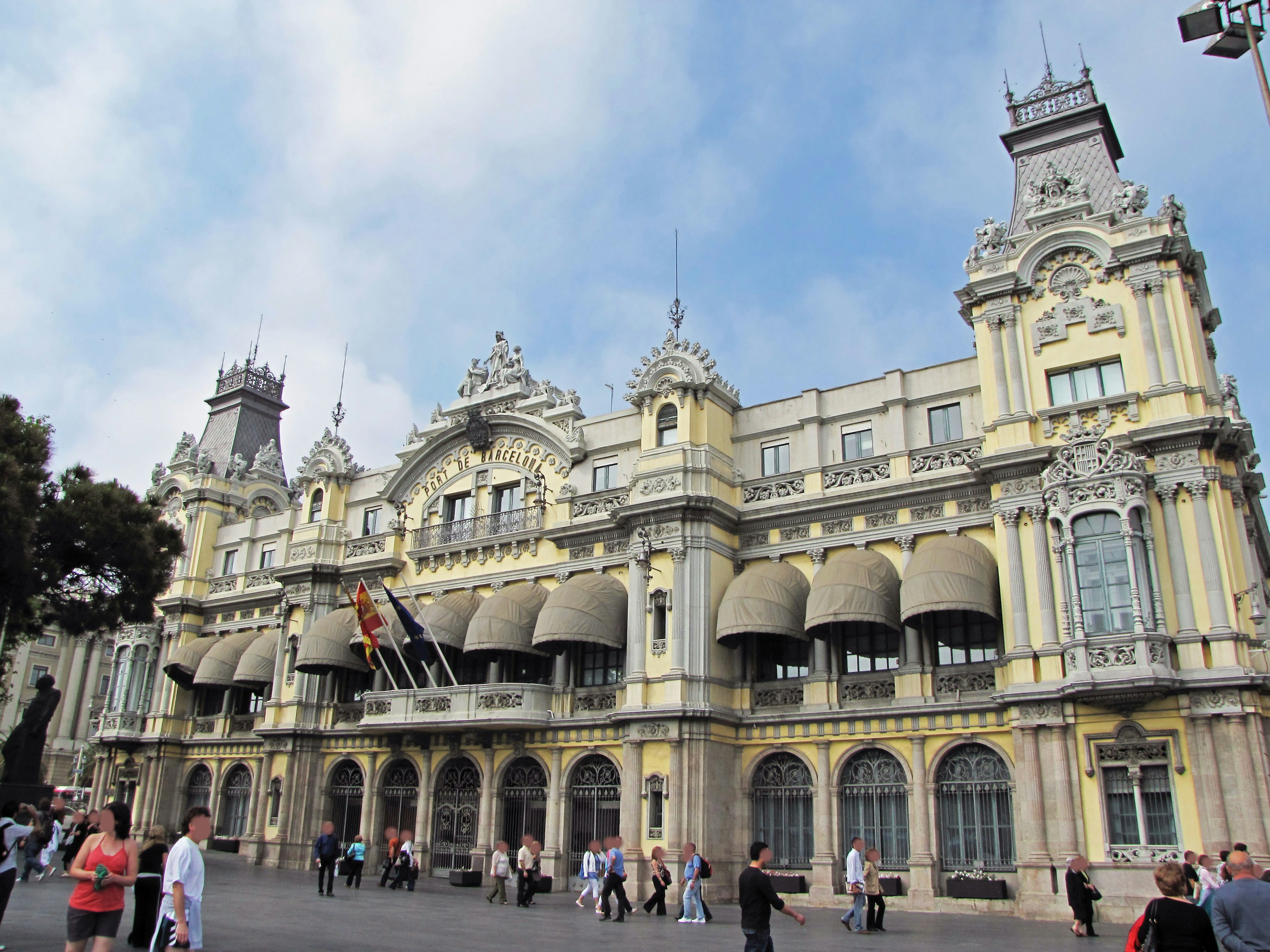 Beautiful historical building with yellow exterior featuring large arched windows and decorative roofs