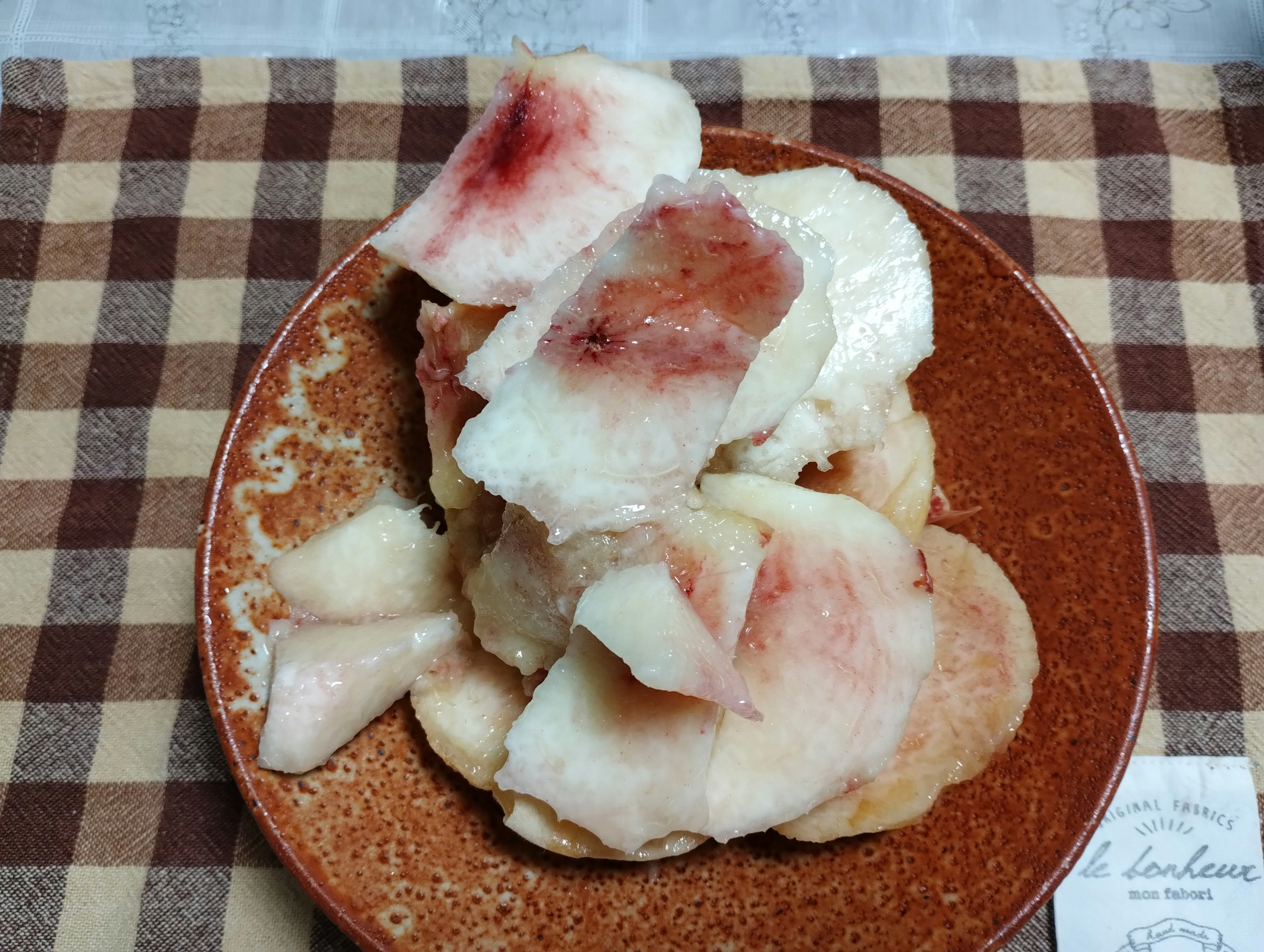 Sliced peach dessert on a brown plate