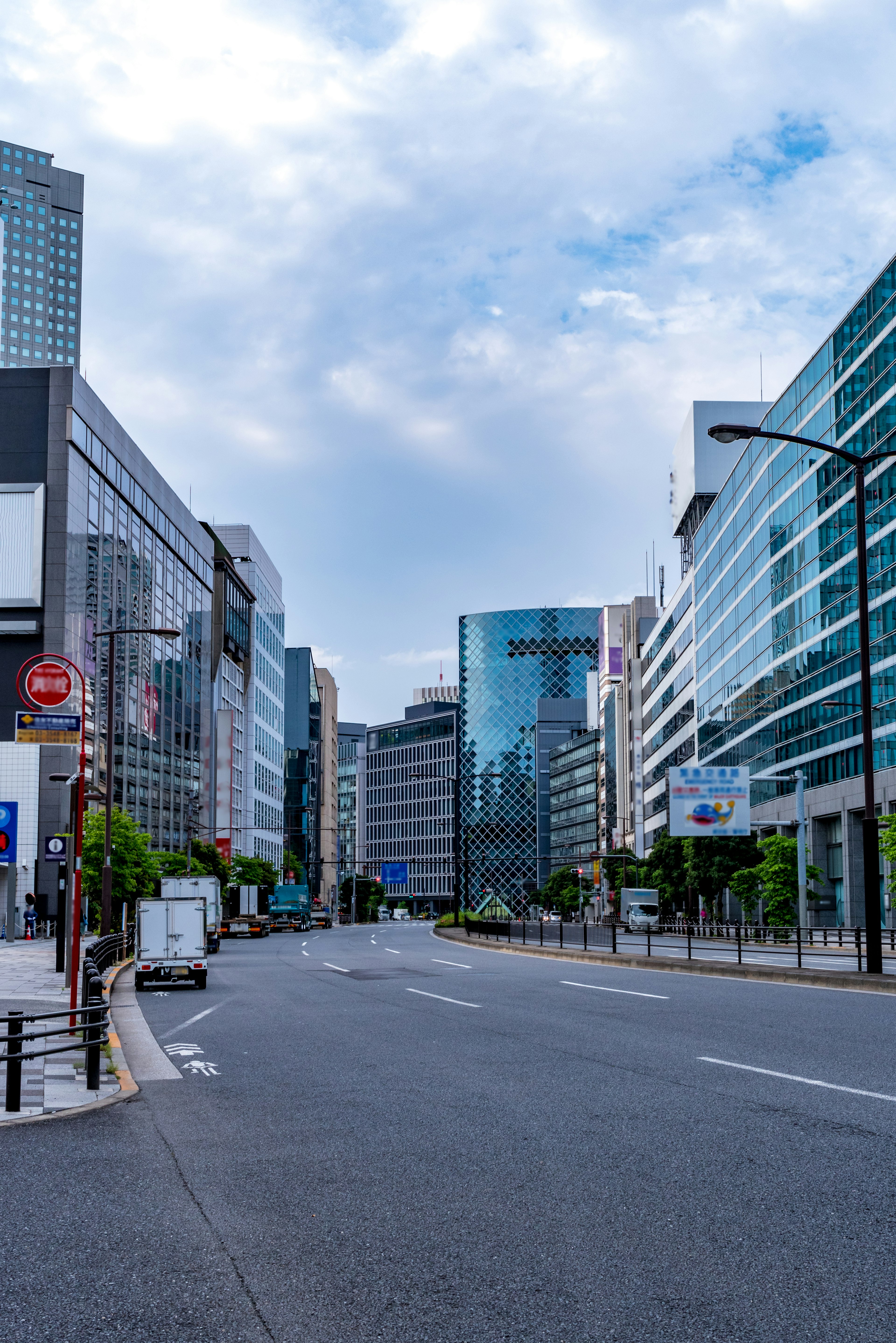 Quiet urban street featuring modern buildings and blue sky