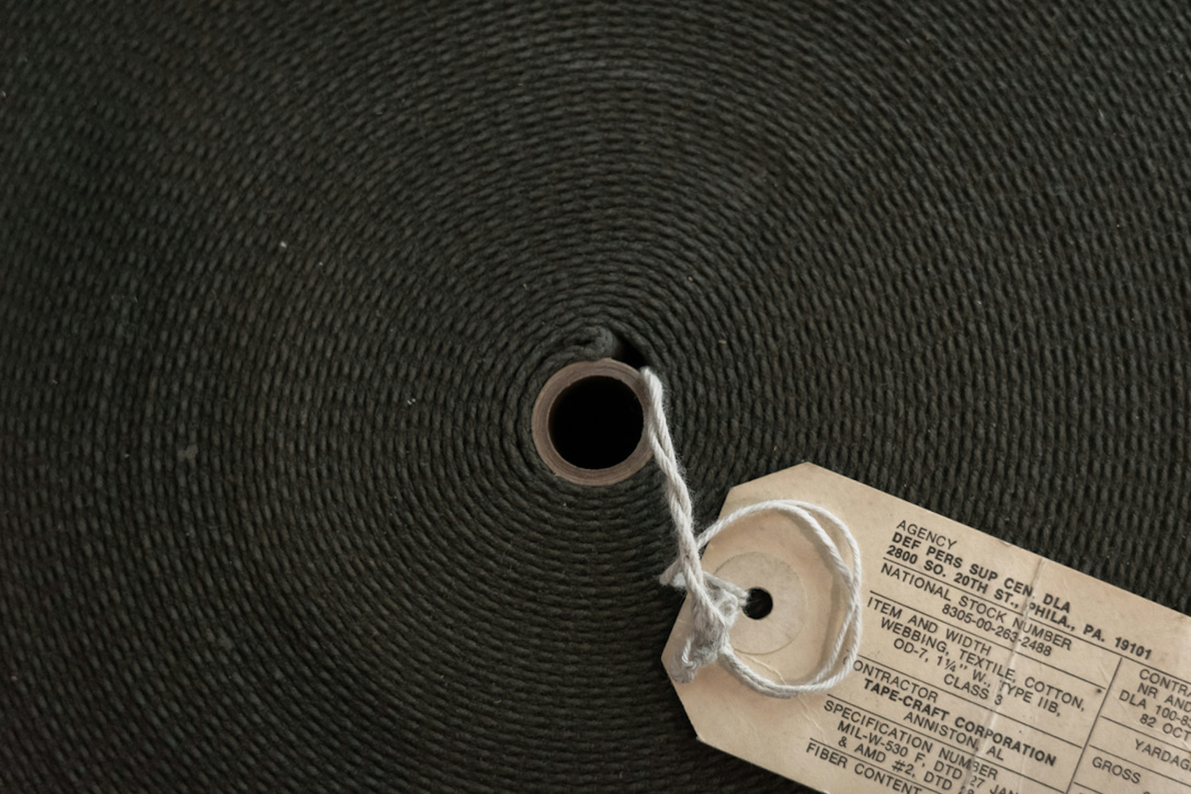 Close-up of a green roll with a central hole and a tag attached