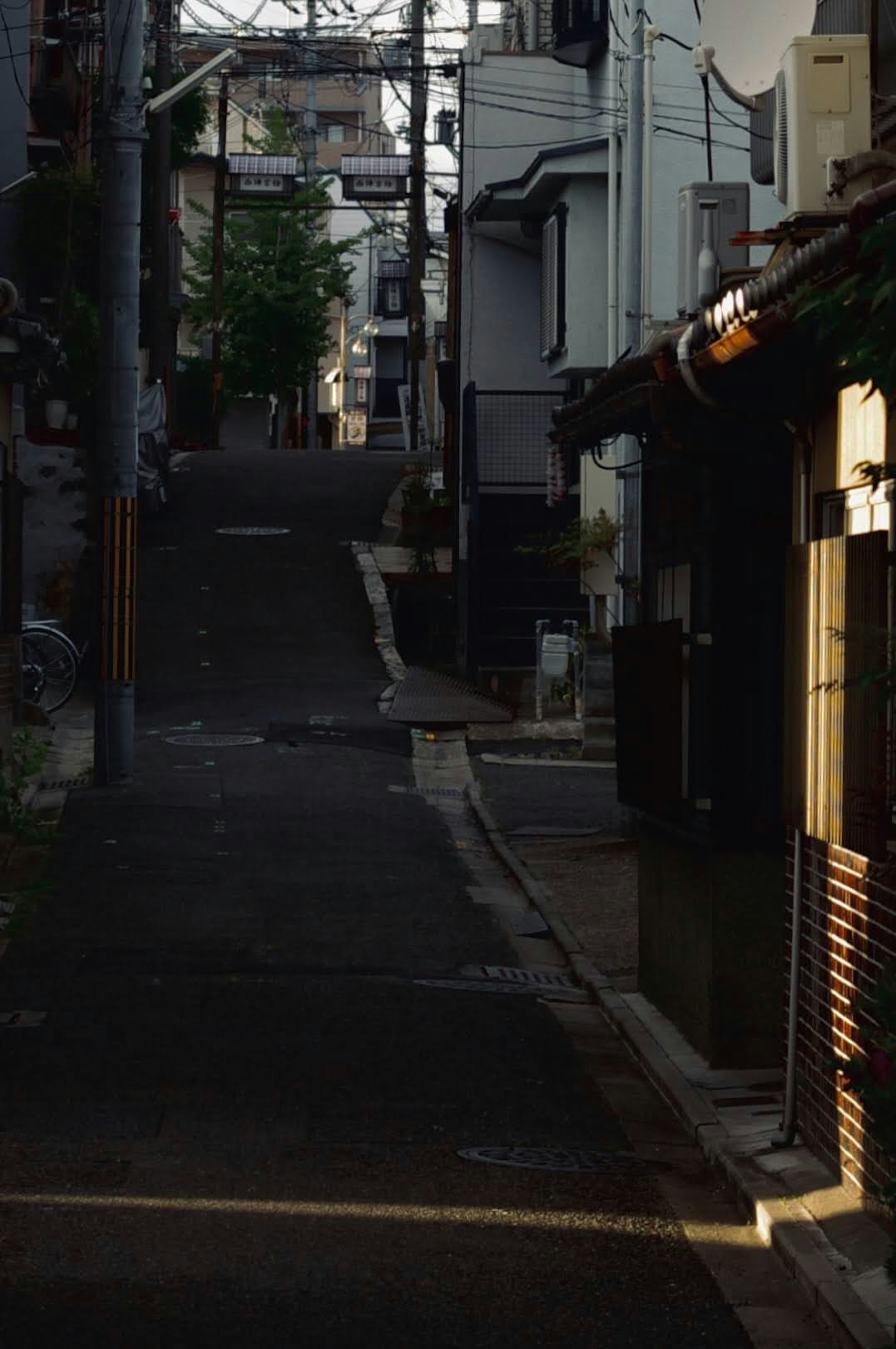 Quiet Japanese back alley with evening light illuminating the scene