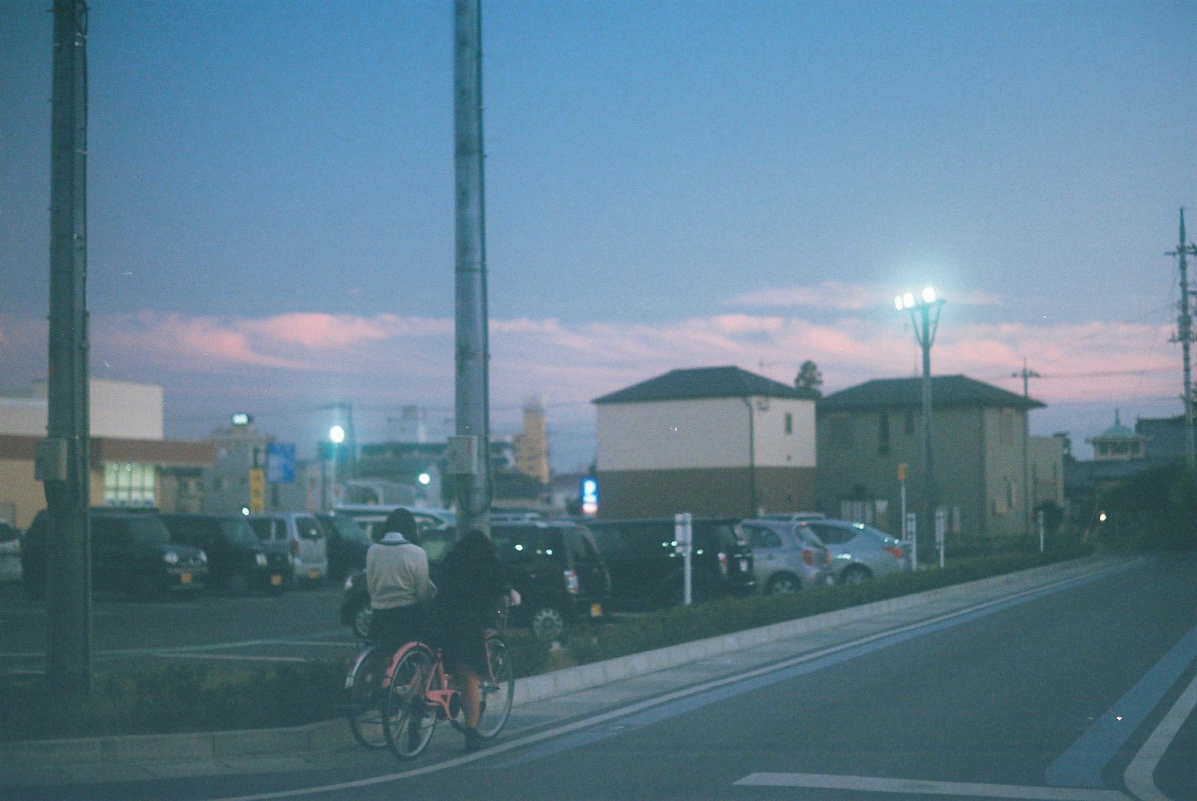 夕暮れ時の街並みと自転車に乗る人々