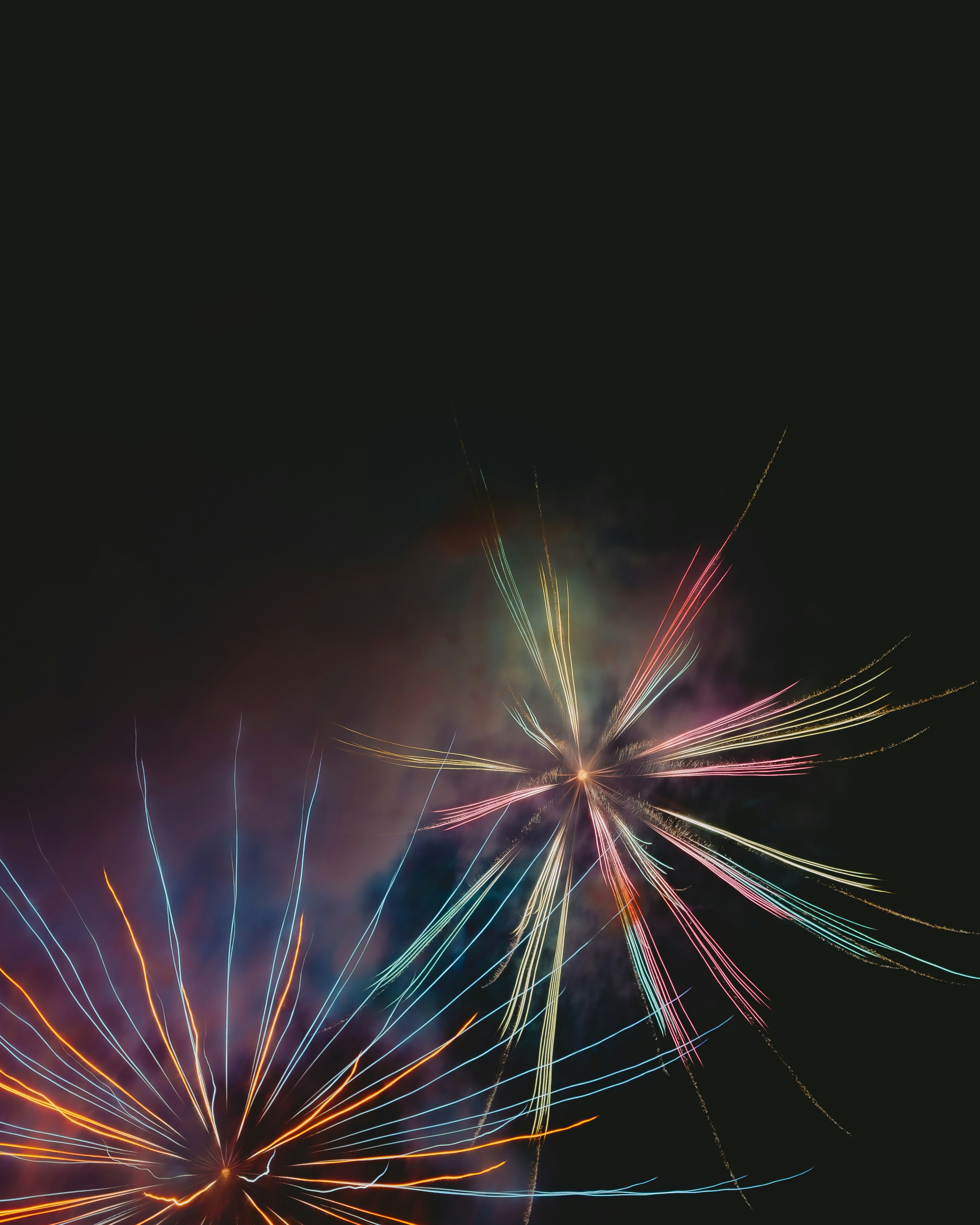 Colorful fireworks bursting against a dark background