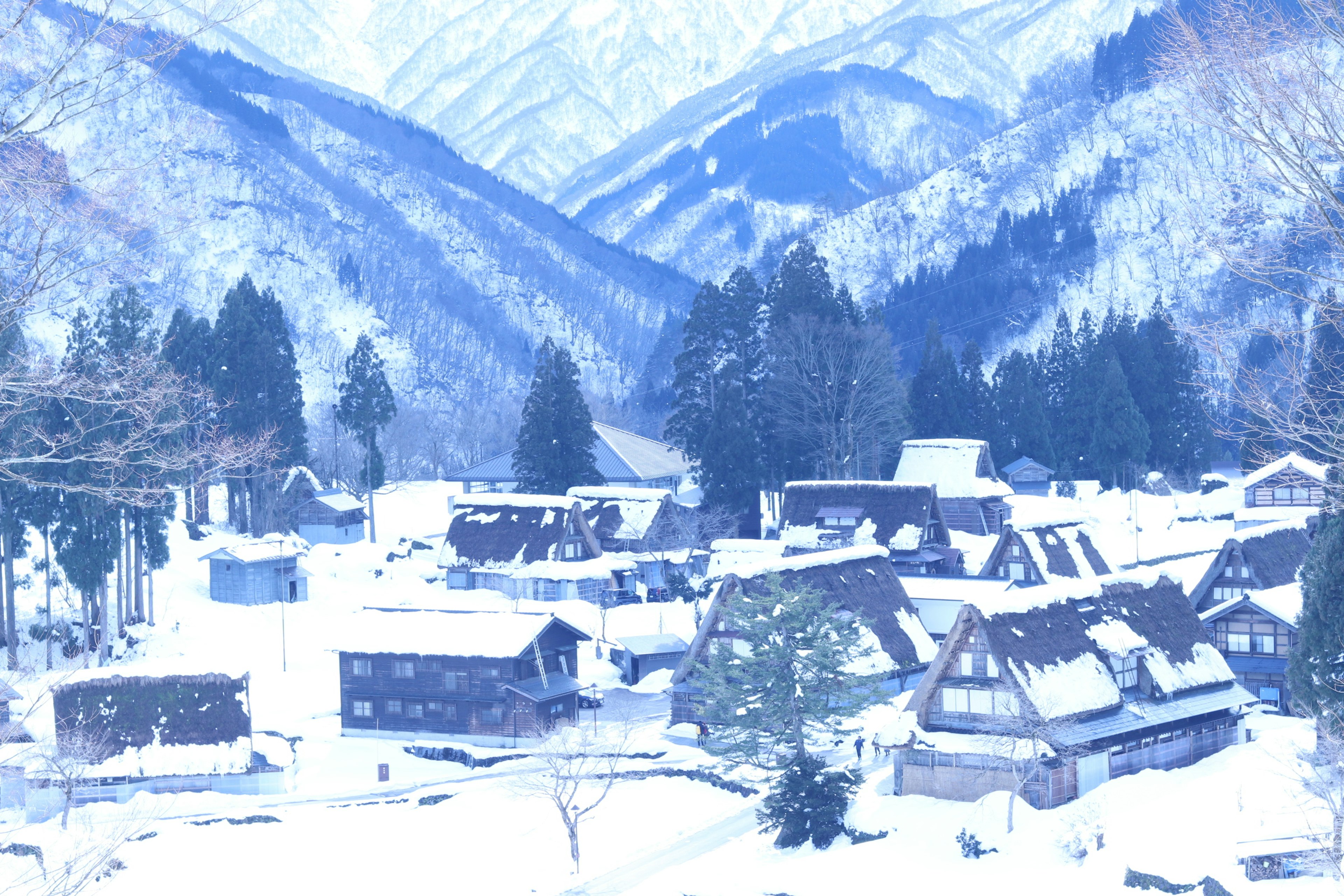 Snow-covered mountain village landscape traditional thatched-roof houses and beautiful mountains