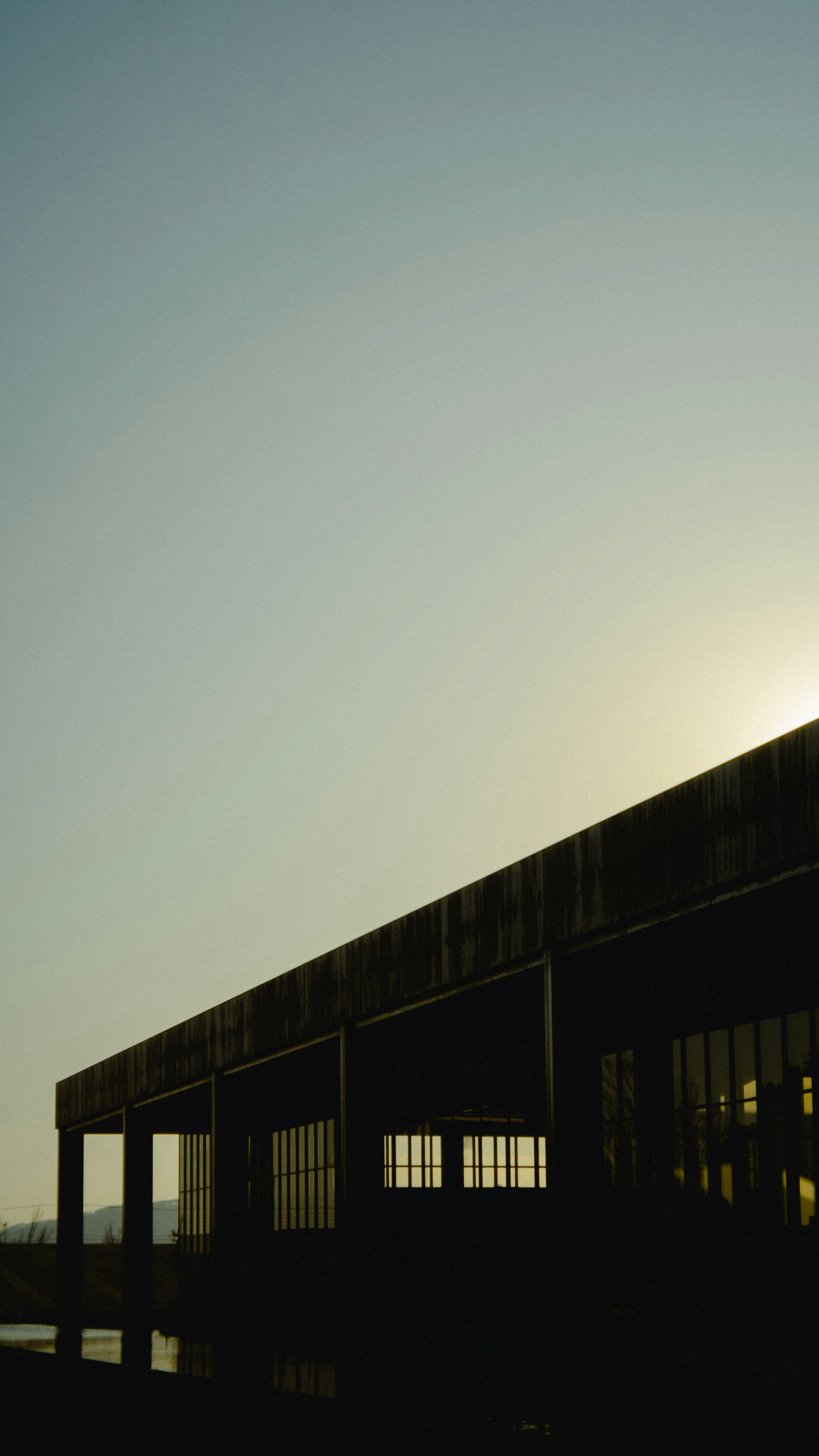 Silhouette of a building illuminated by sunset light