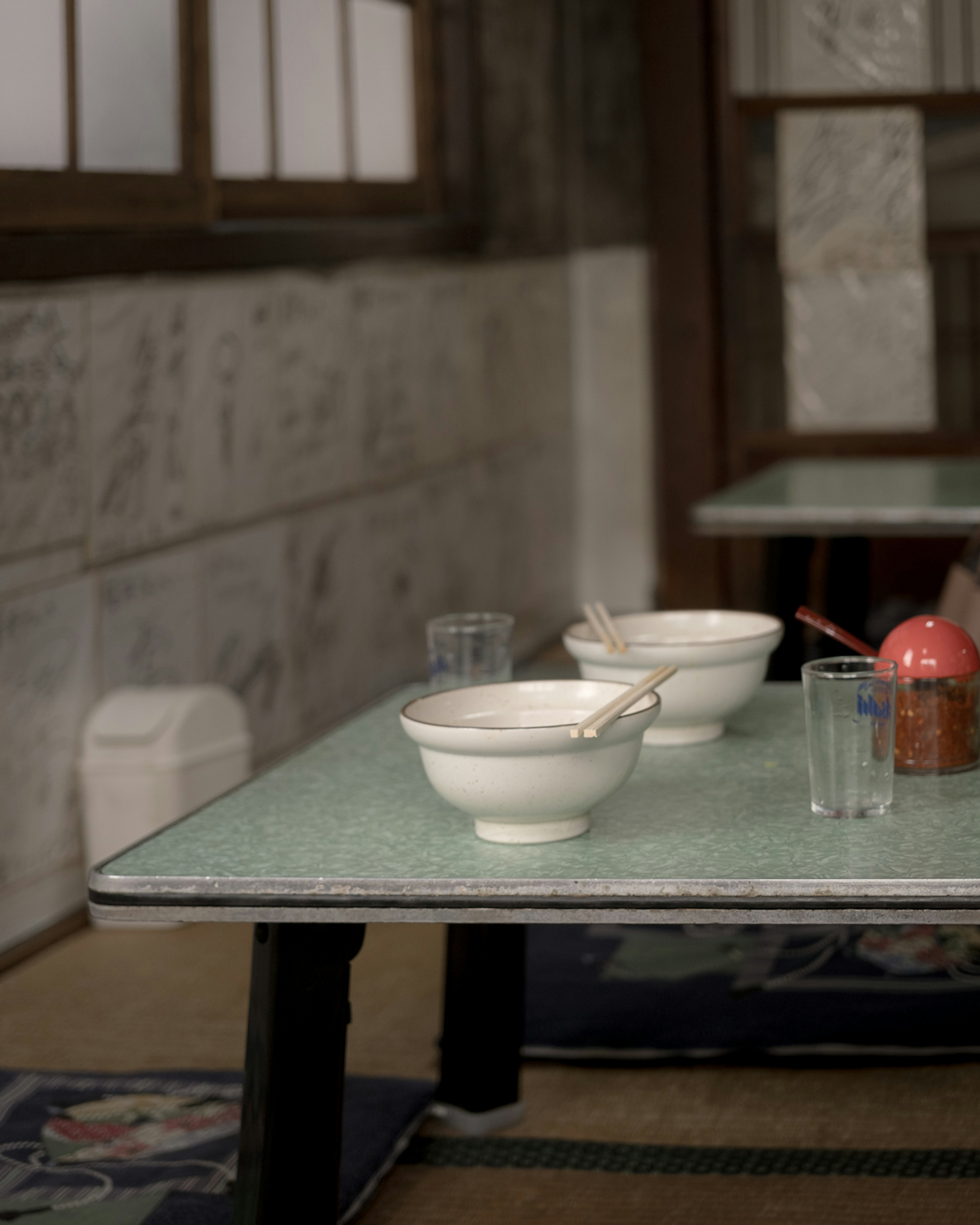 Japanese-style dining table with white bowls and glasses