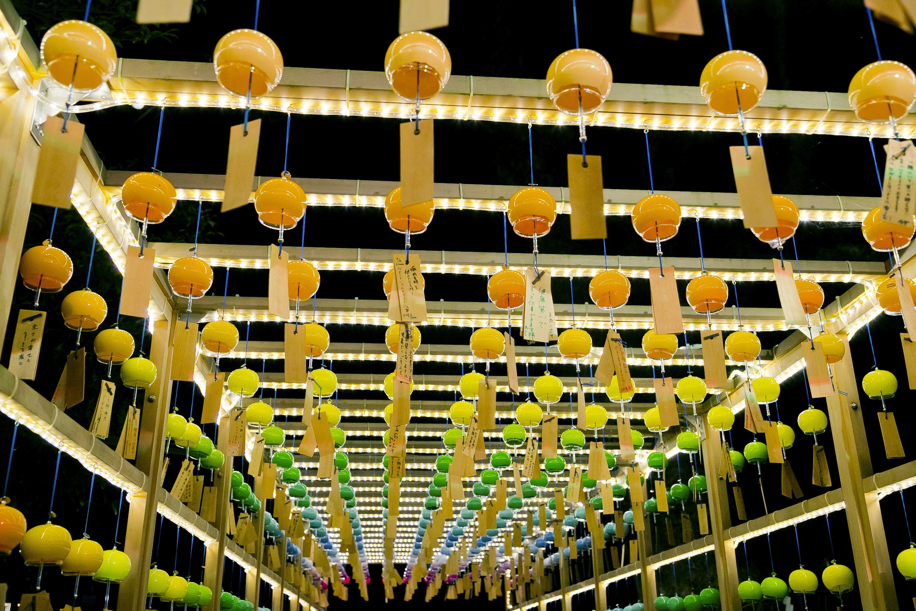 View of a tunnel adorned with colorful lanterns hanging from above