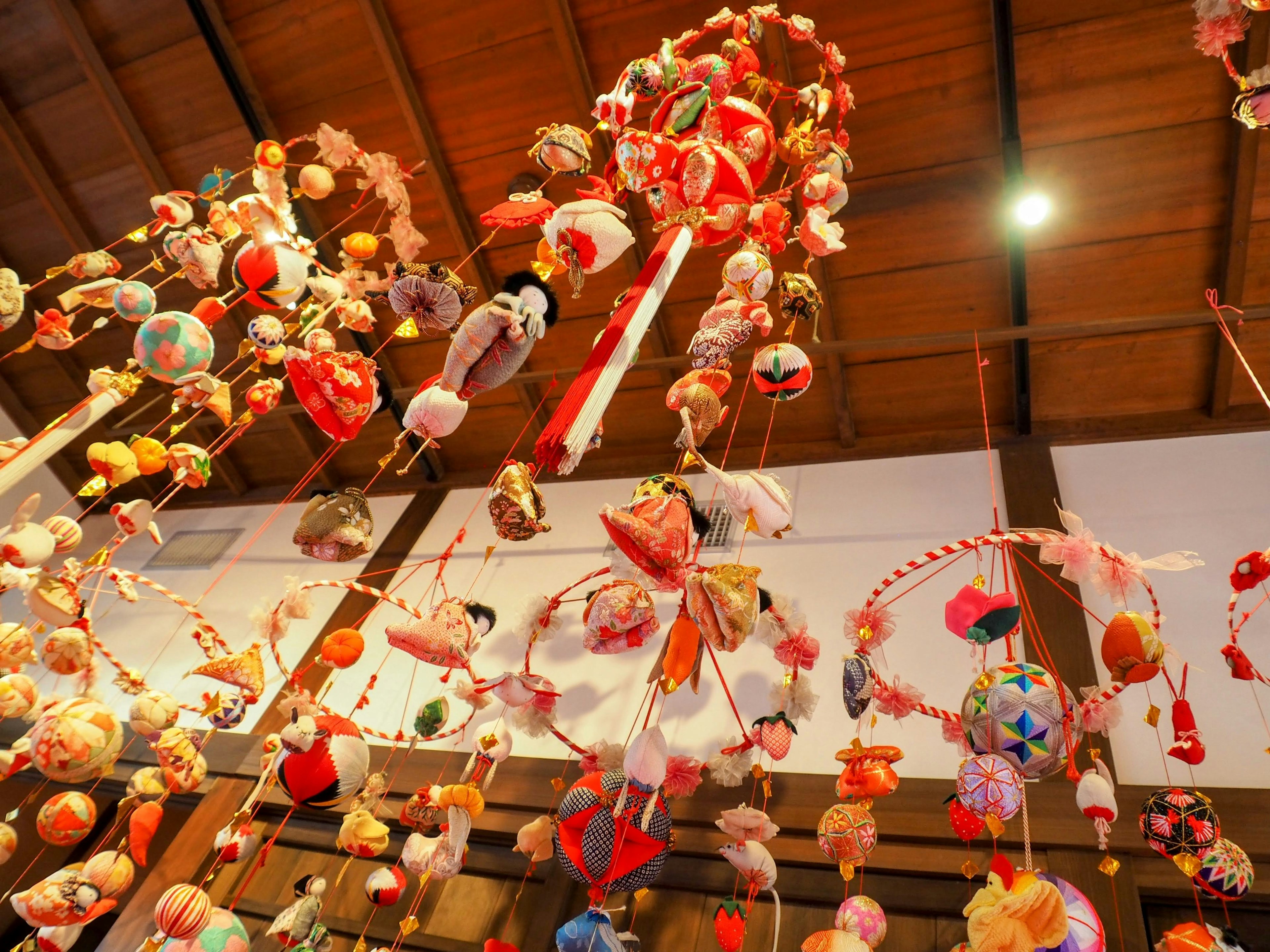 Colorful traditional Japanese hanging hina dolls suspended from the ceiling