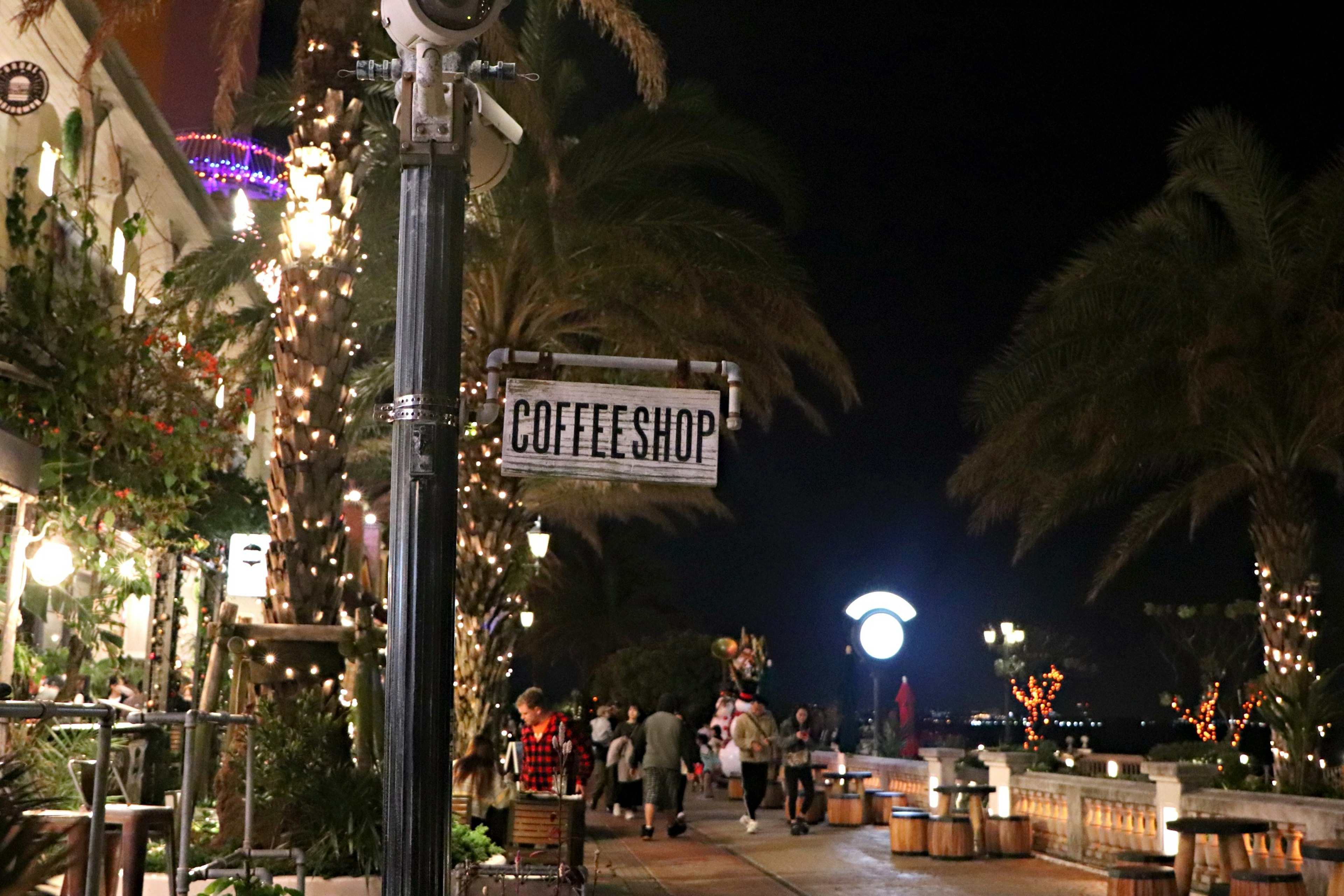 Night view of a coffee shop with lively street ambiance