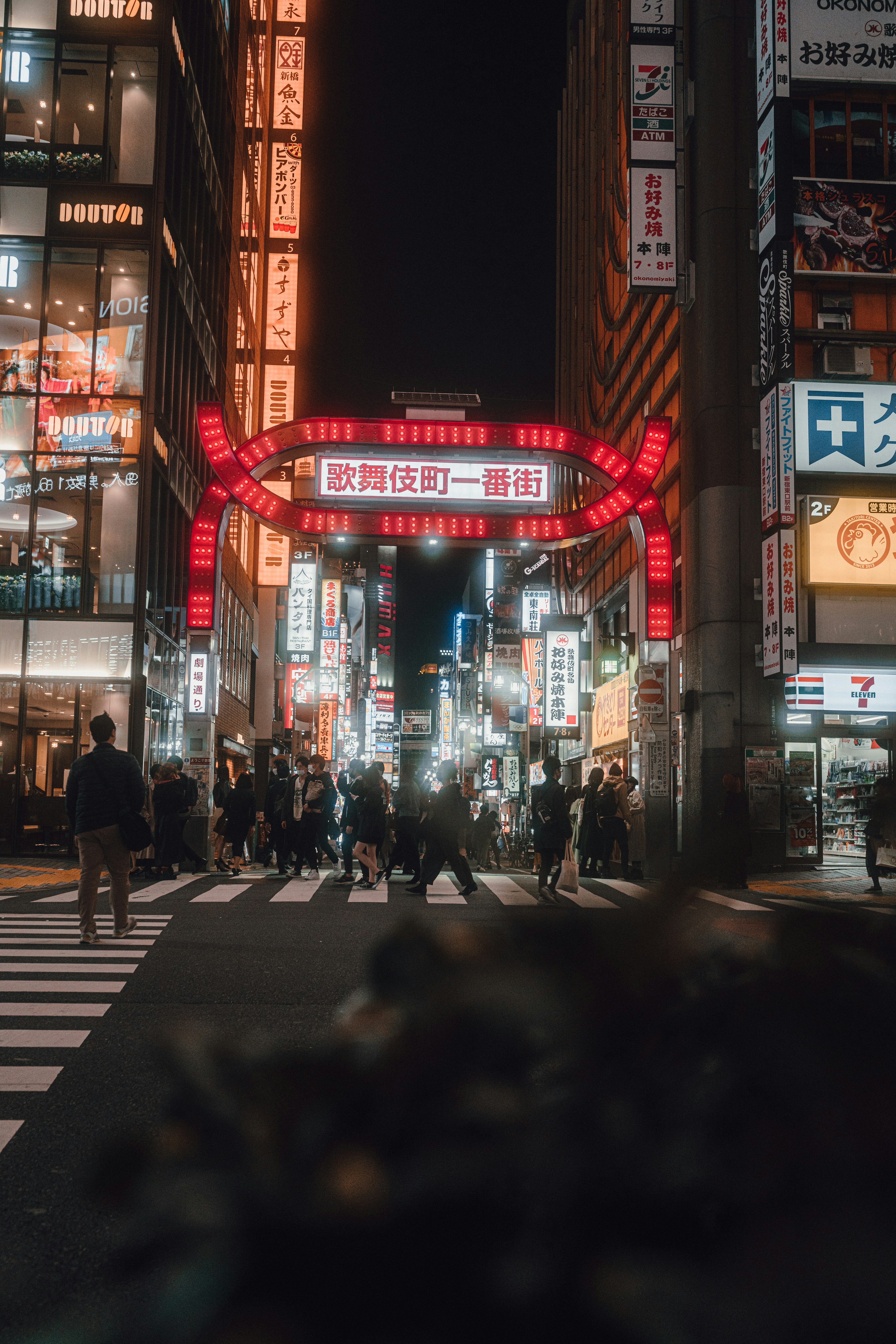 Night cityscape with glowing neon signs in a bustling street