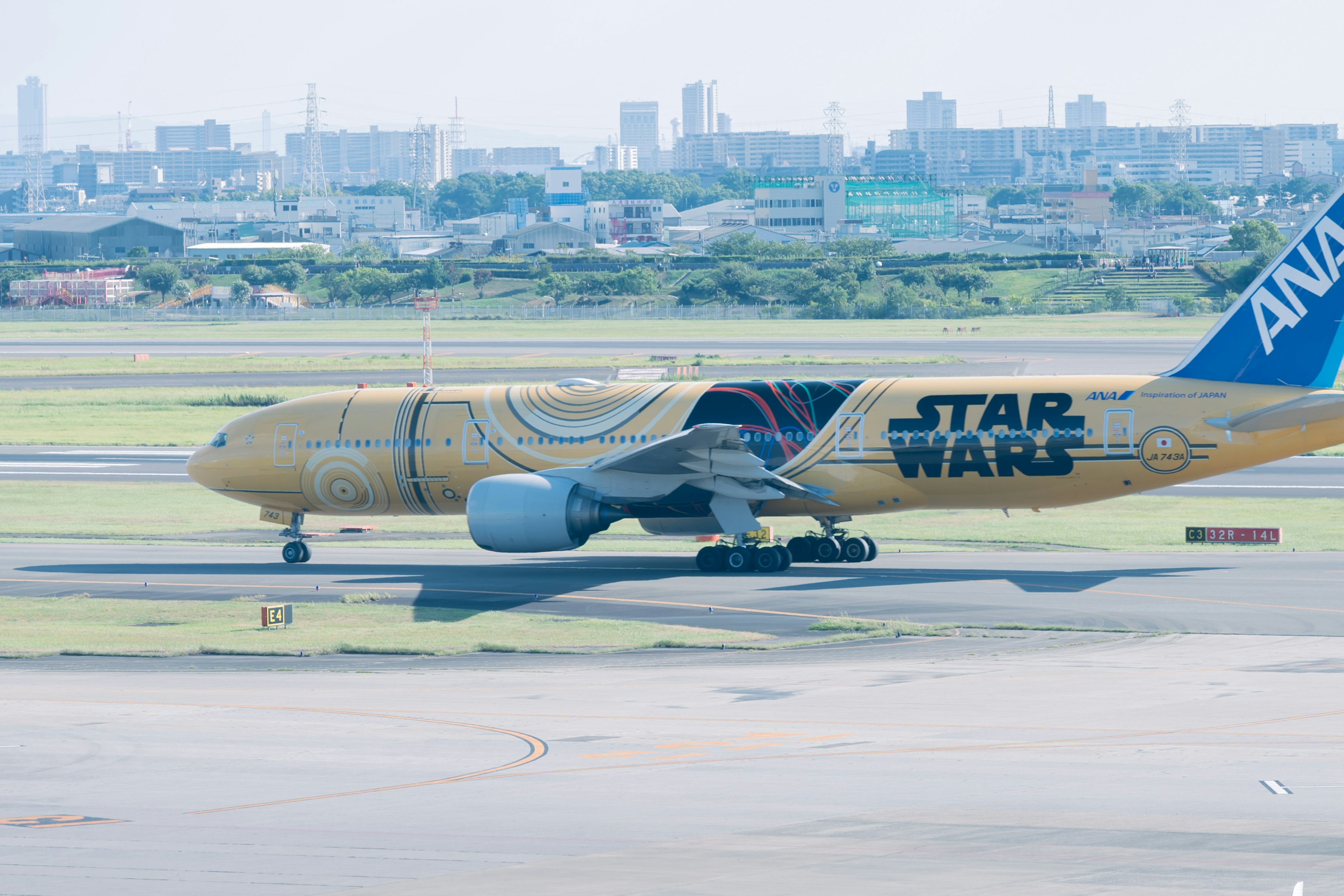 ANA airplane with Star Wars design taxiing on runway