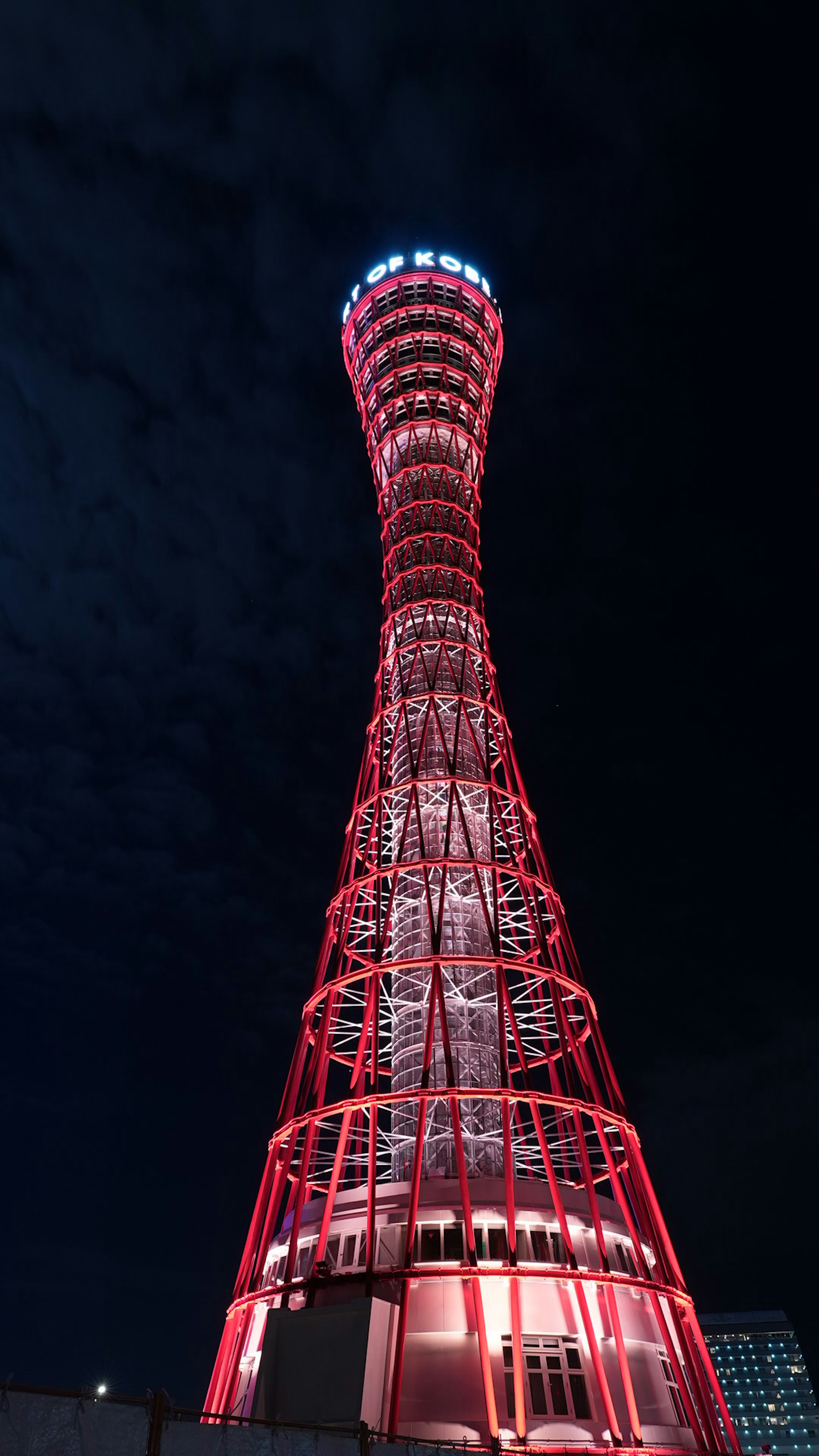 Torre di Kobe di notte illuminata da luci rosse che mostrano la sua bella struttura