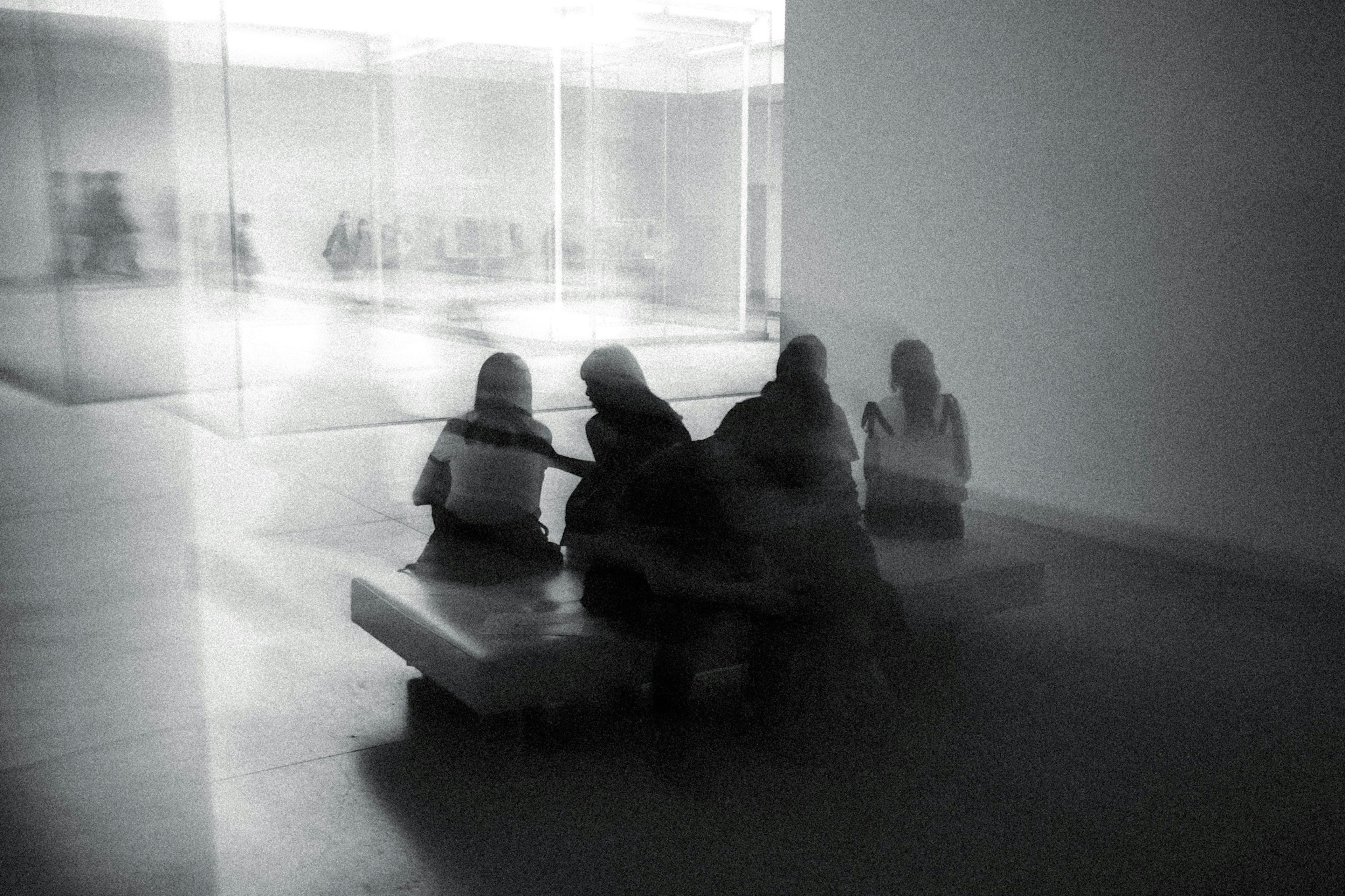 Silhouetten von Menschen, die Kunst in einem modernen Museum betrachten