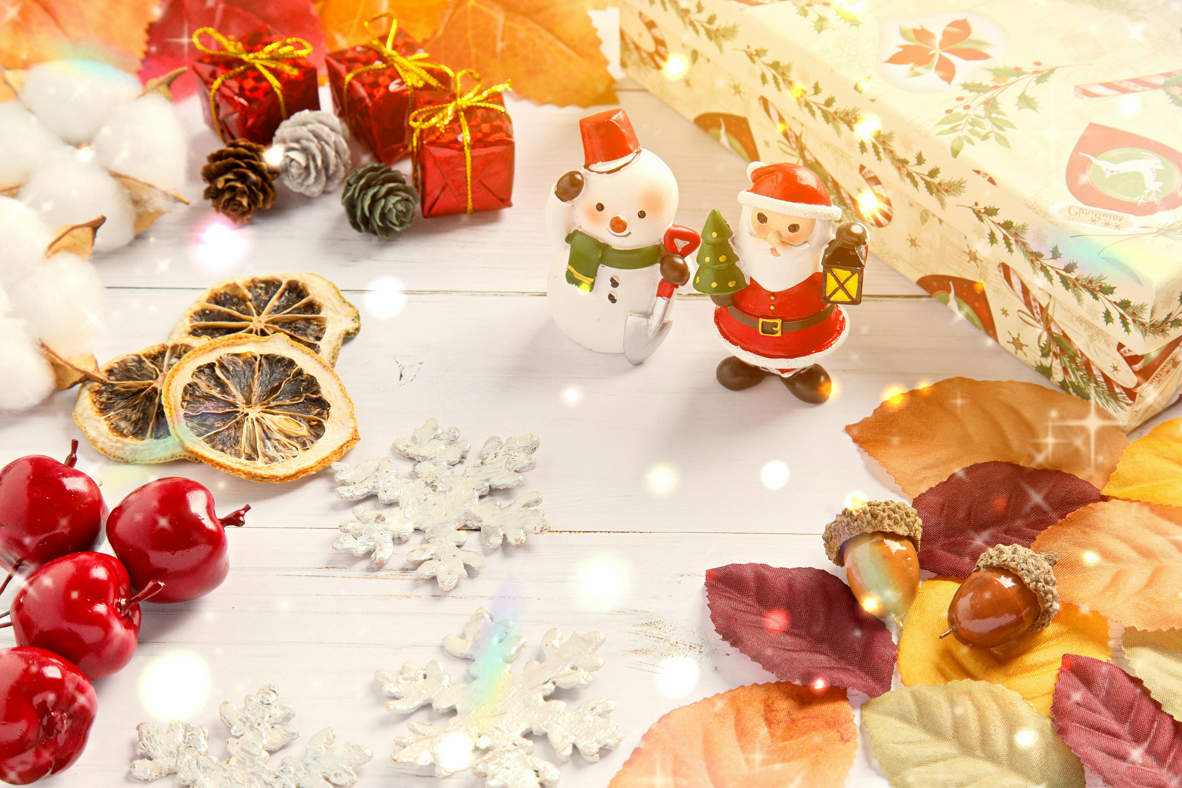 Warm Christmas scene with decorations and gifts including Santa figures