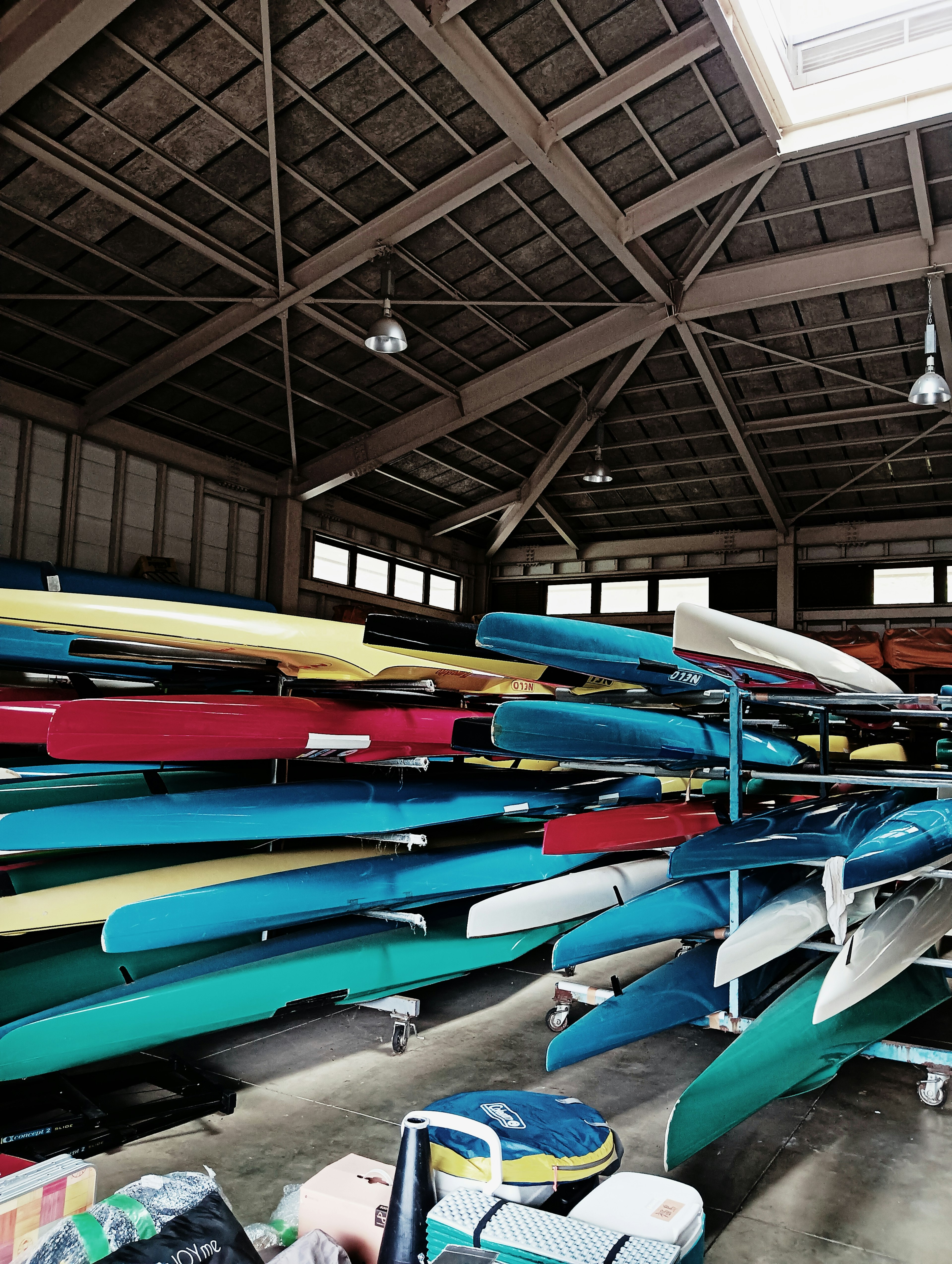 Colorful kayaks stacked inside a warehouse