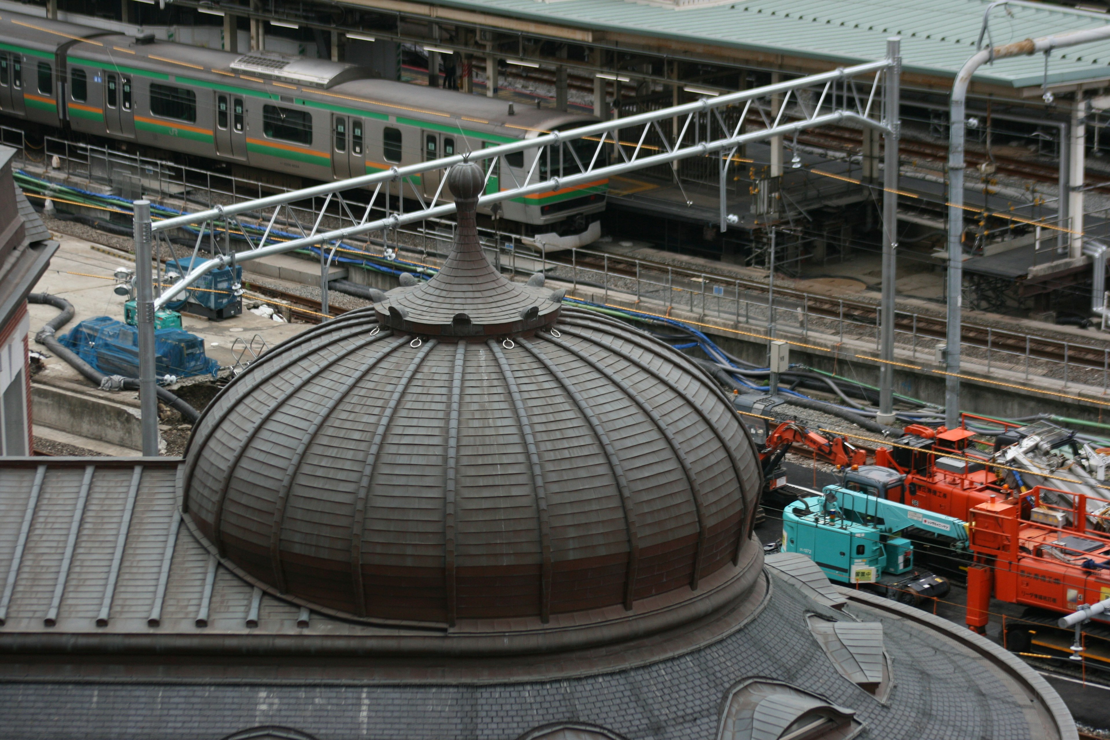 Dome of a train station with surrounding railway tracks and equipment