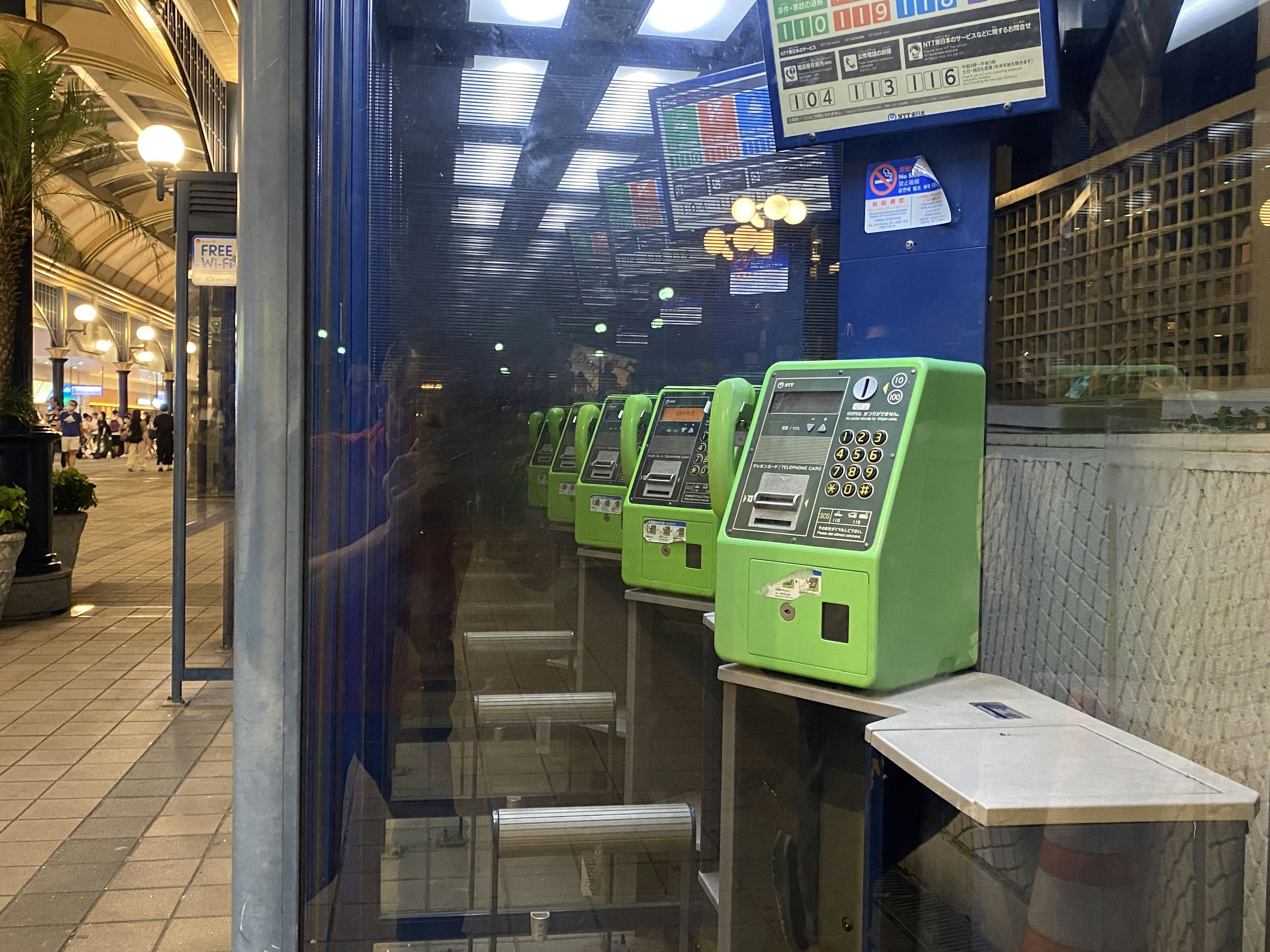 Interior view of green ticket machines lined up at a station