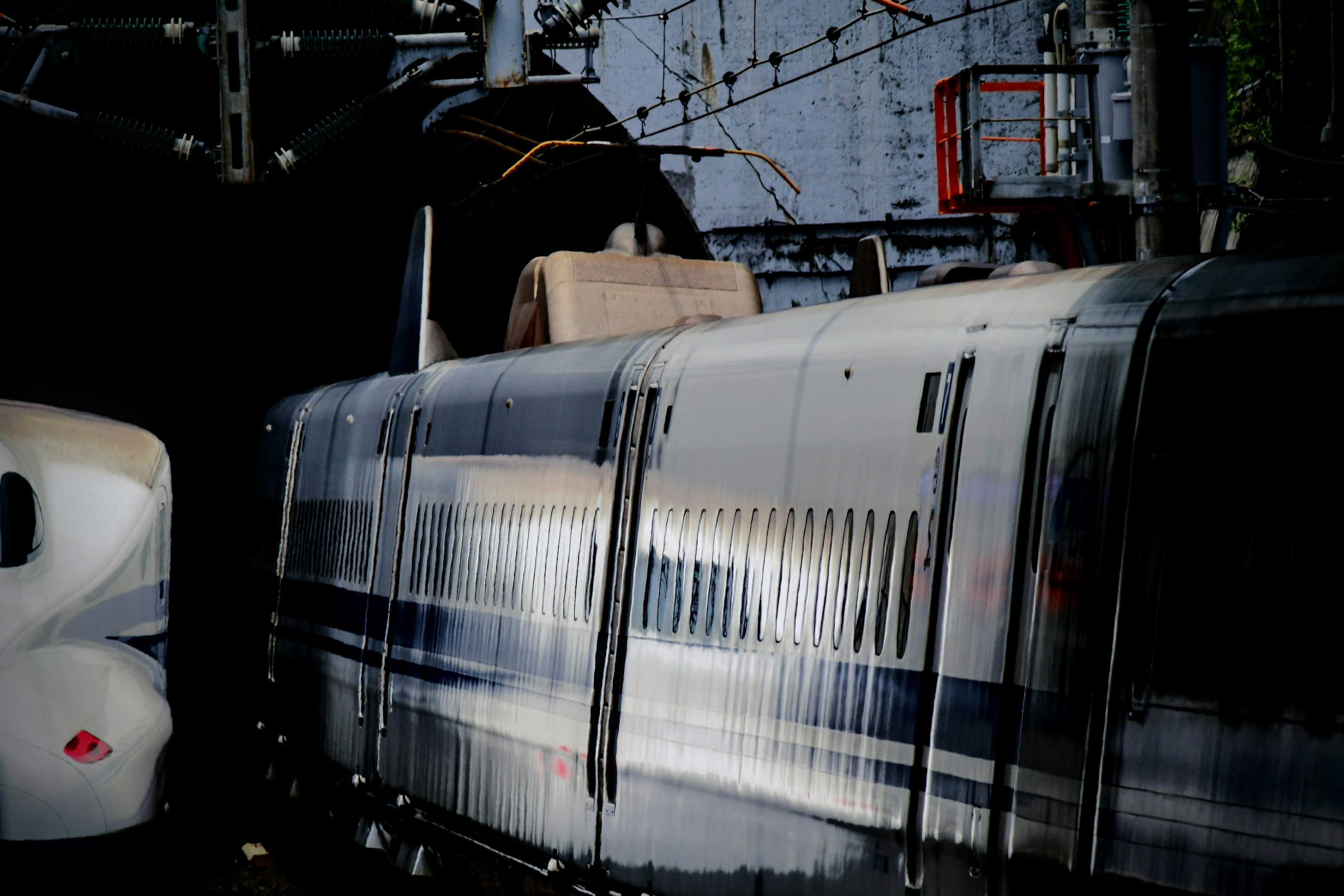 High-speed train at a station with reflective surfaces