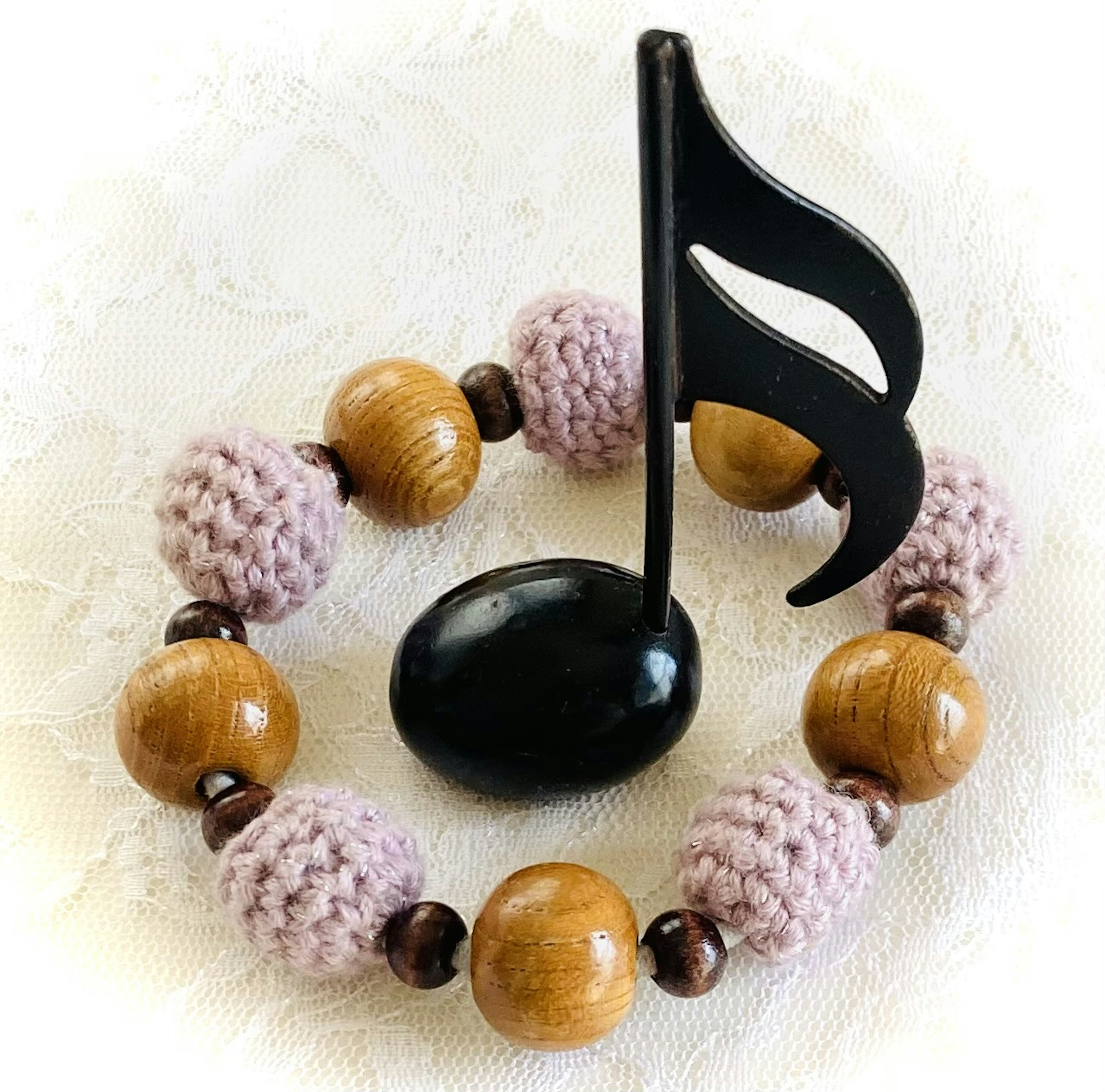 Bracelet featuring a black musical note and wooden beads