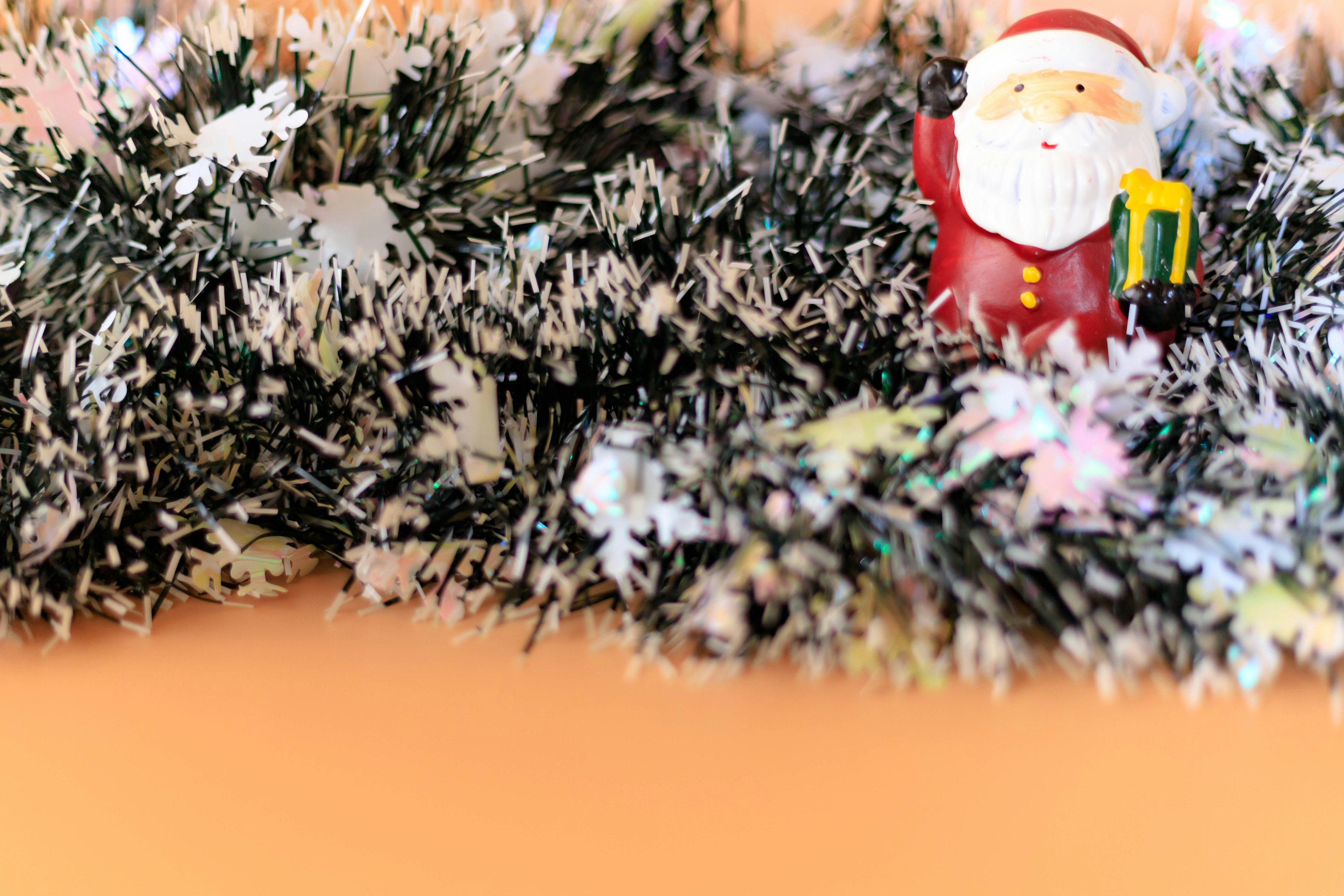 Figurine de Père Noël sur une décoration en guirlande verte et blanche