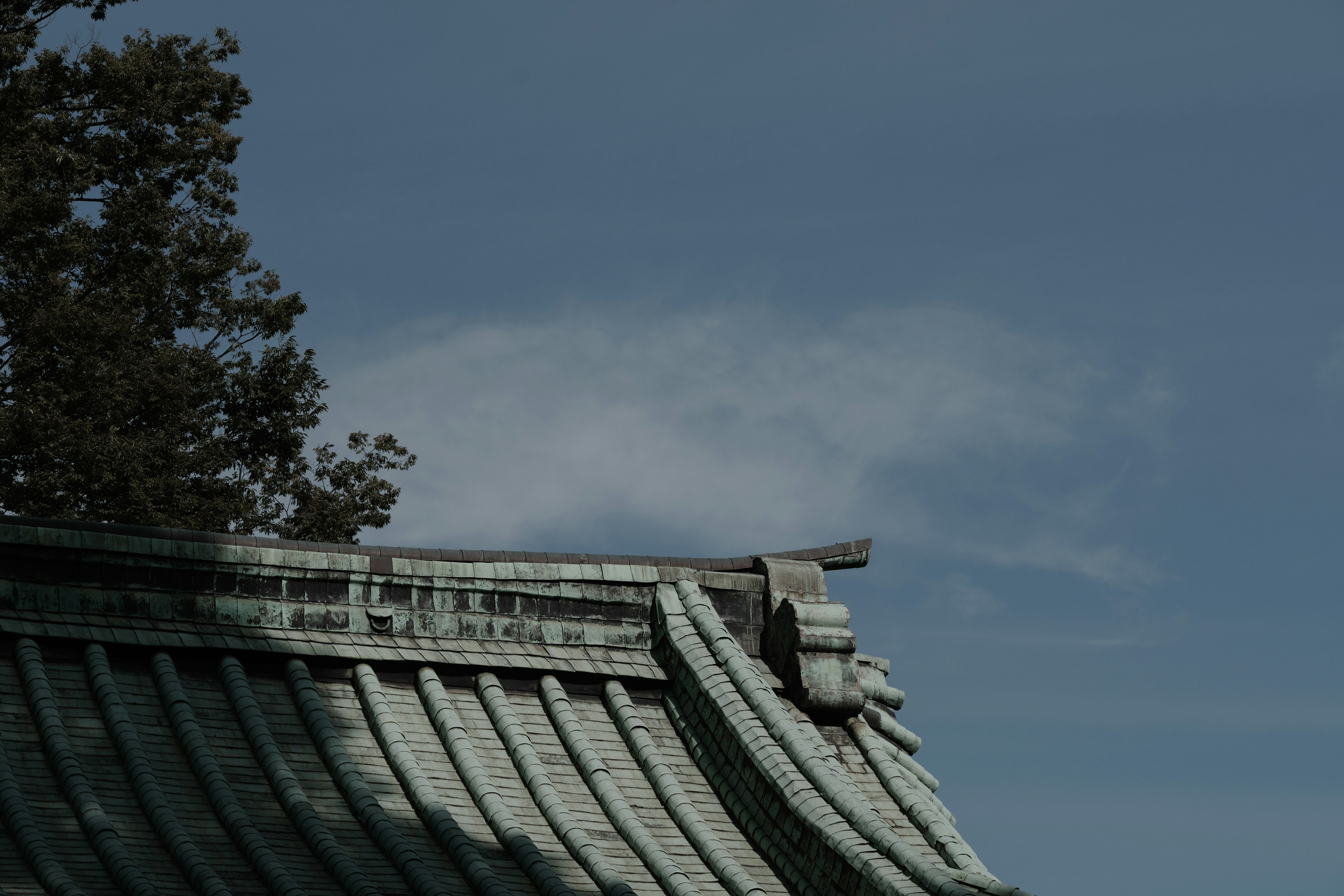 傳統日本建築的屋頂在藍天和雲朵下