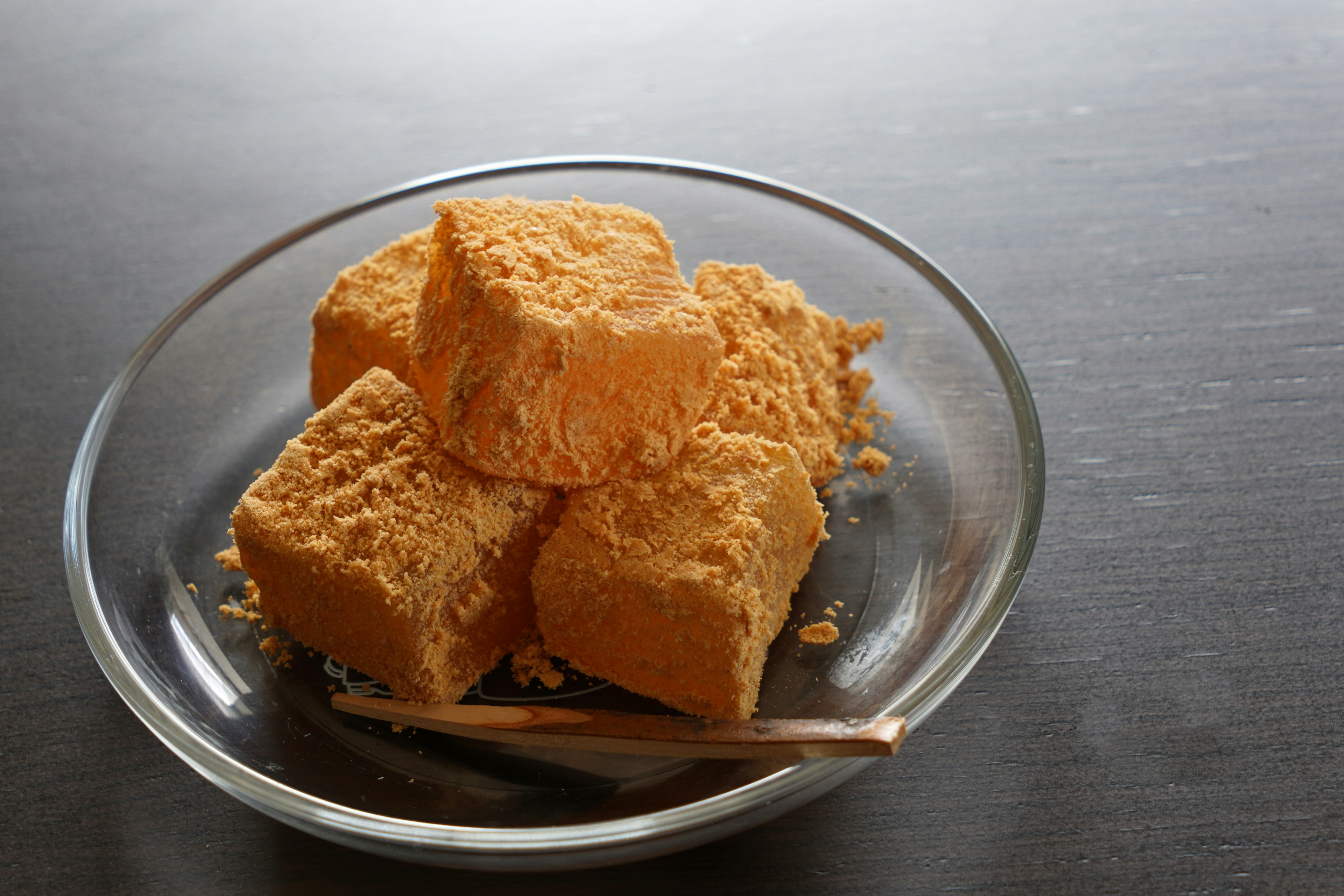 Orange powdery food served in a clear glass dish