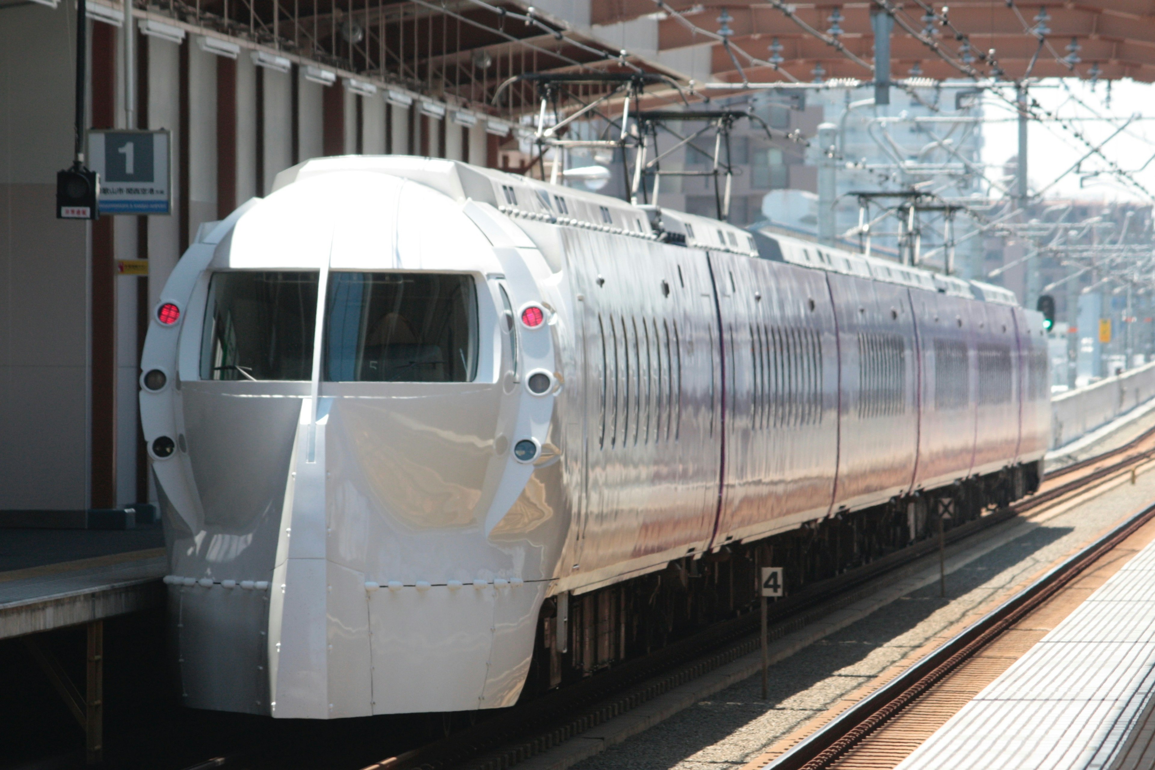 Shiny silver Shinkansen train at the station