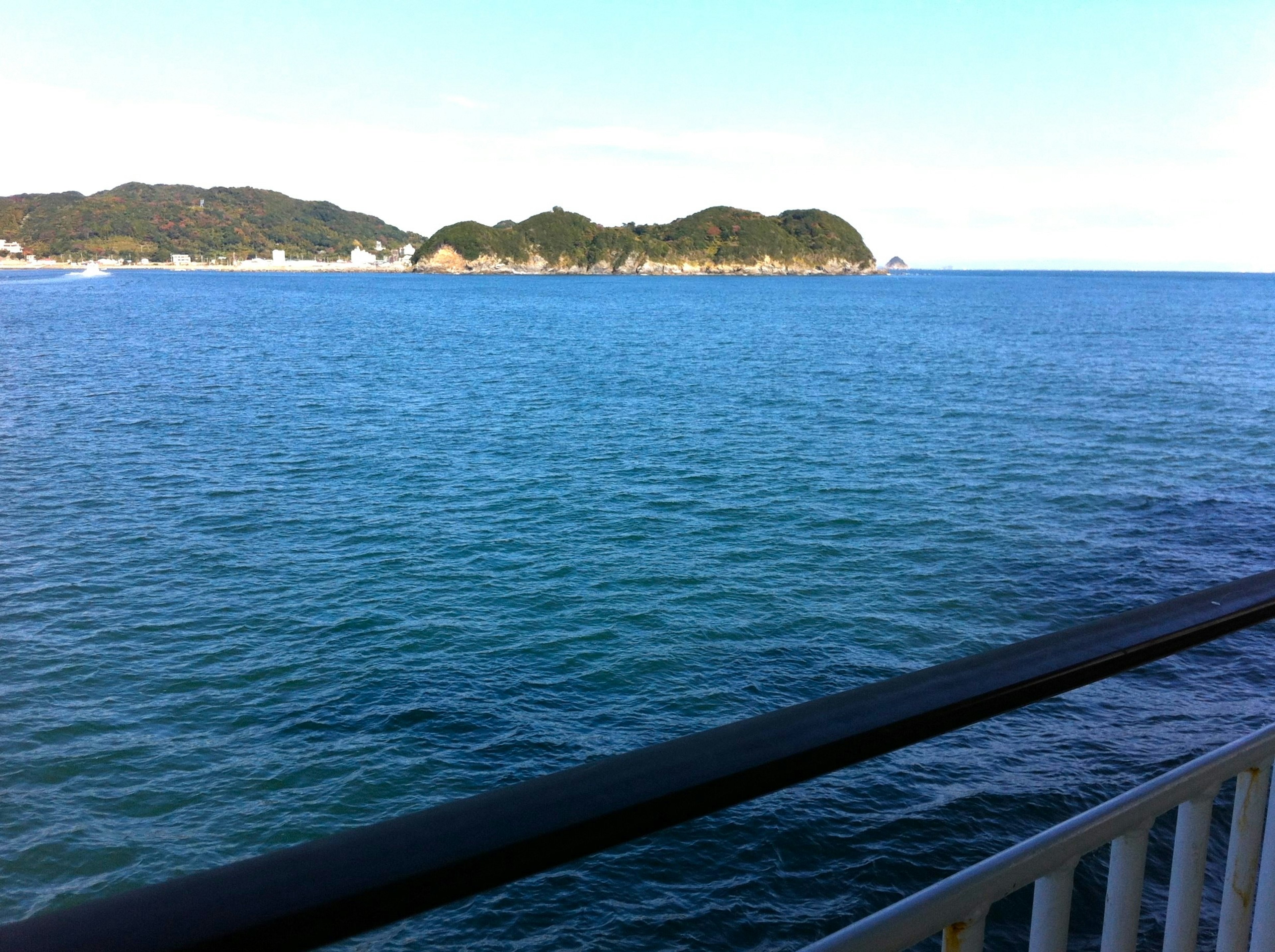 Scenic view of blue ocean and distant islands clear water surface and blue sky