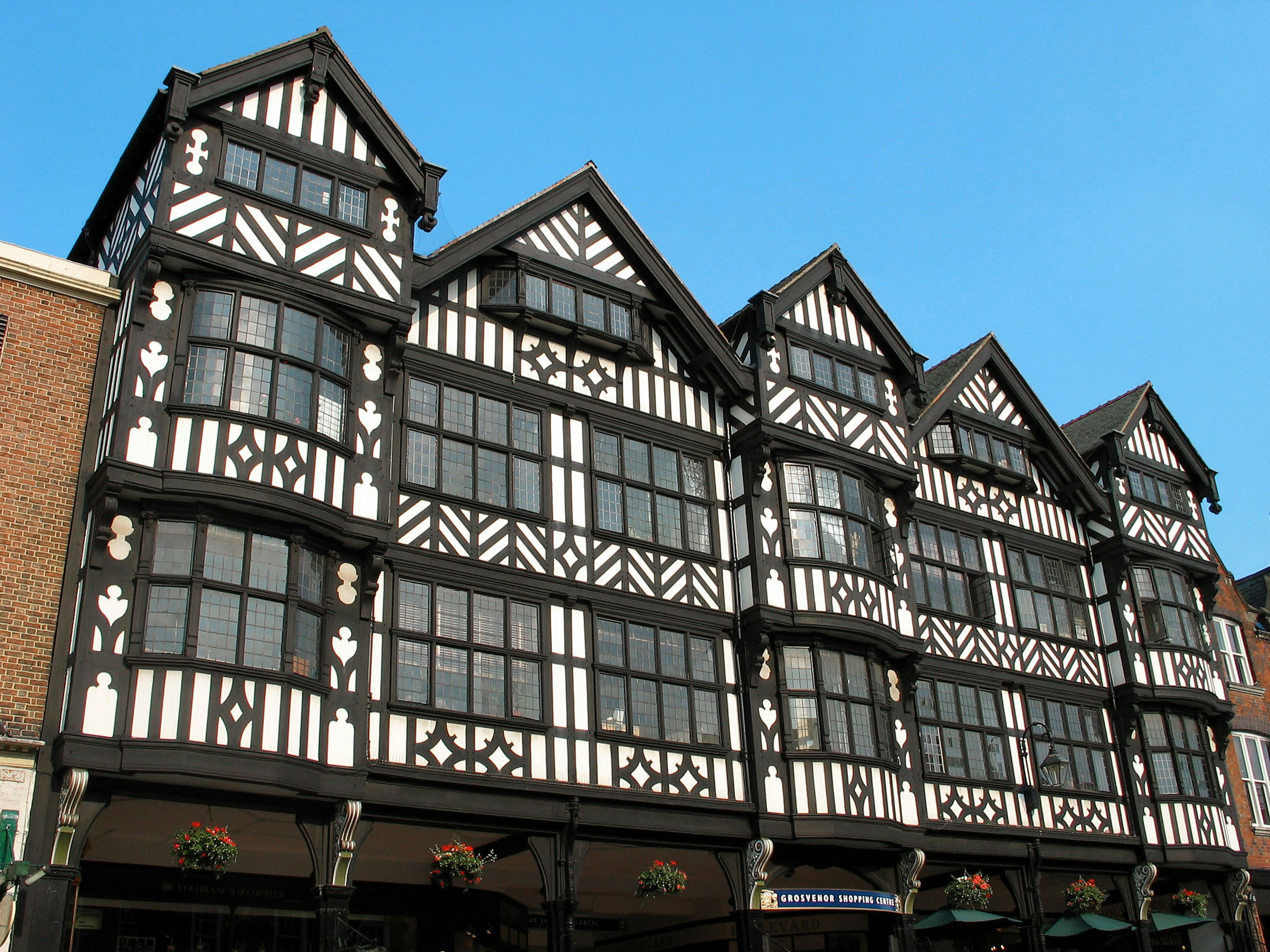 Striking black and white timber-framed building with multiple gabled roofs