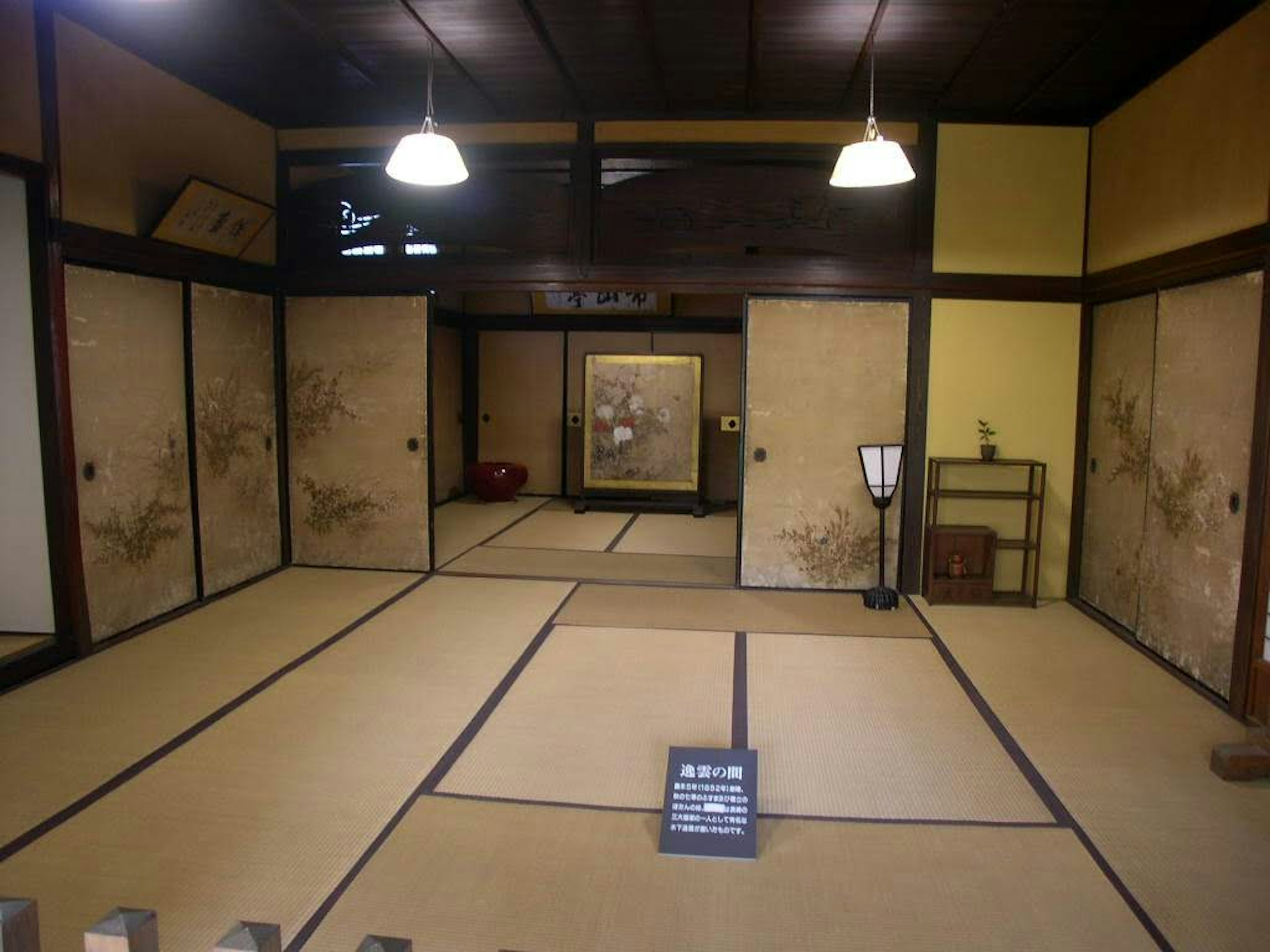 Interior of a traditional Japanese room with tatami flooring sliding doors and Japanese decor