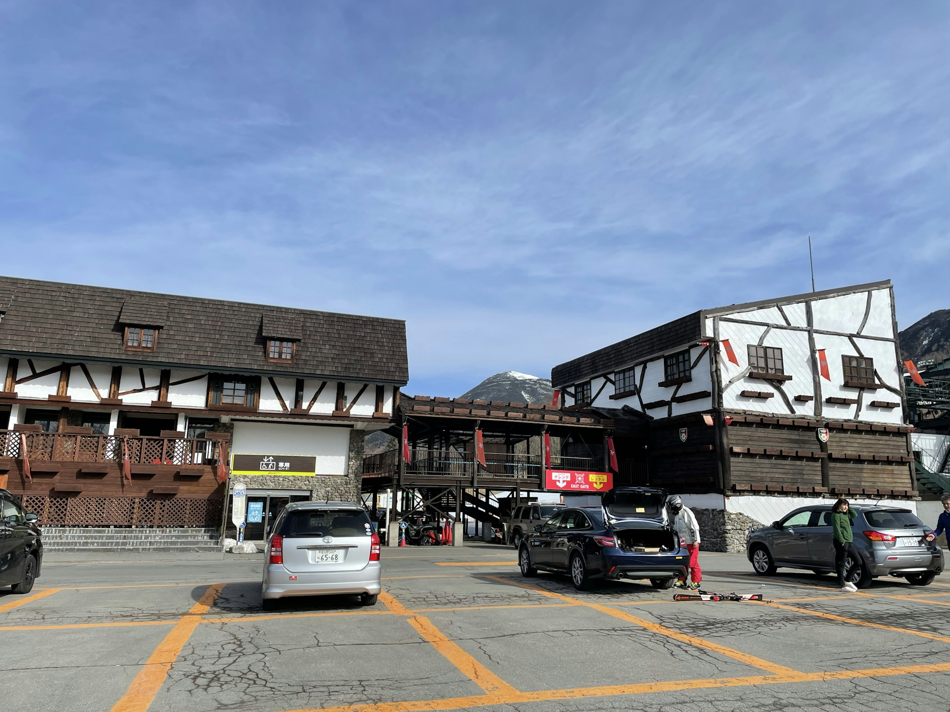 Traditional building and modern cars in a parking lot