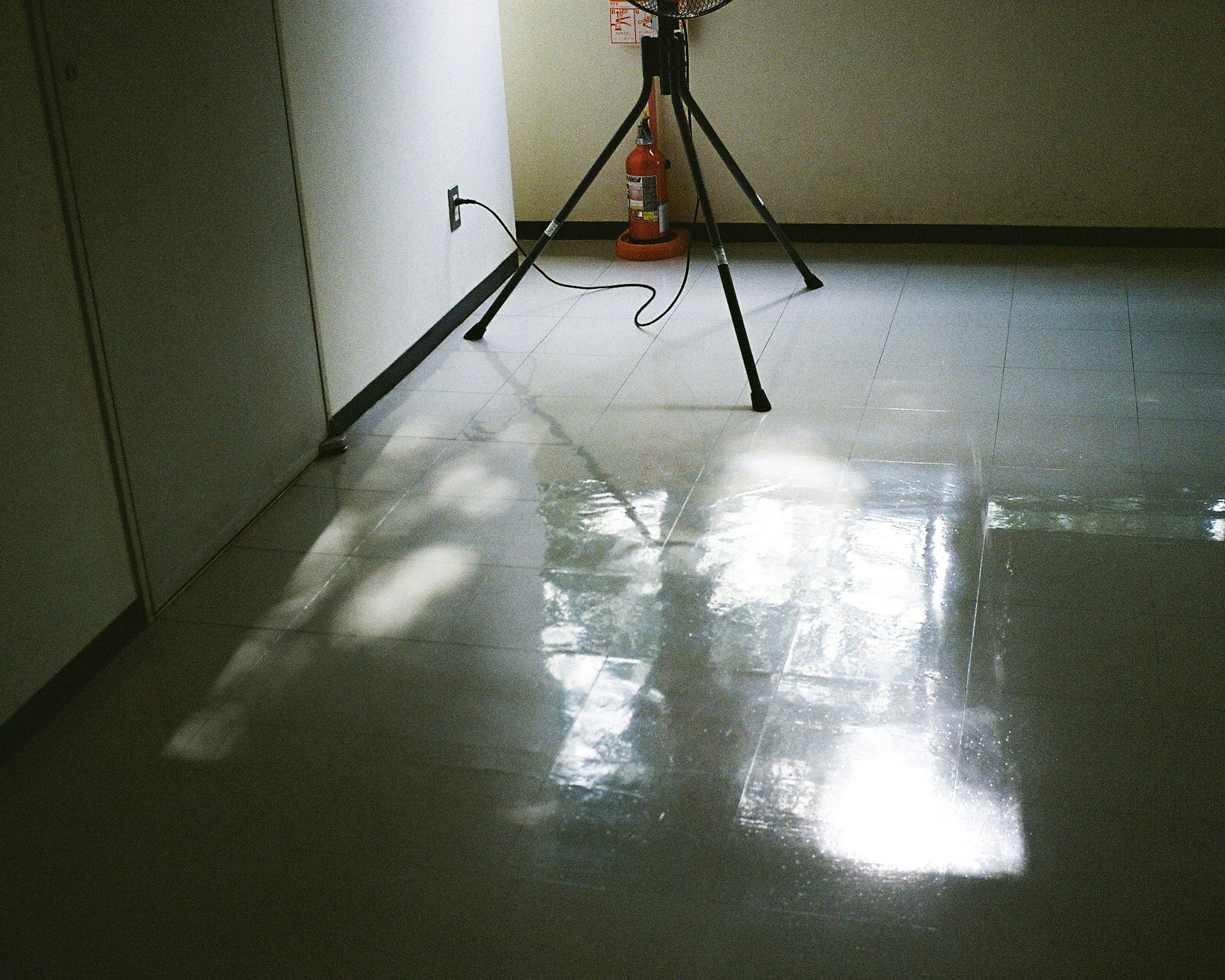 Shiny floor with tripod in an indoor space