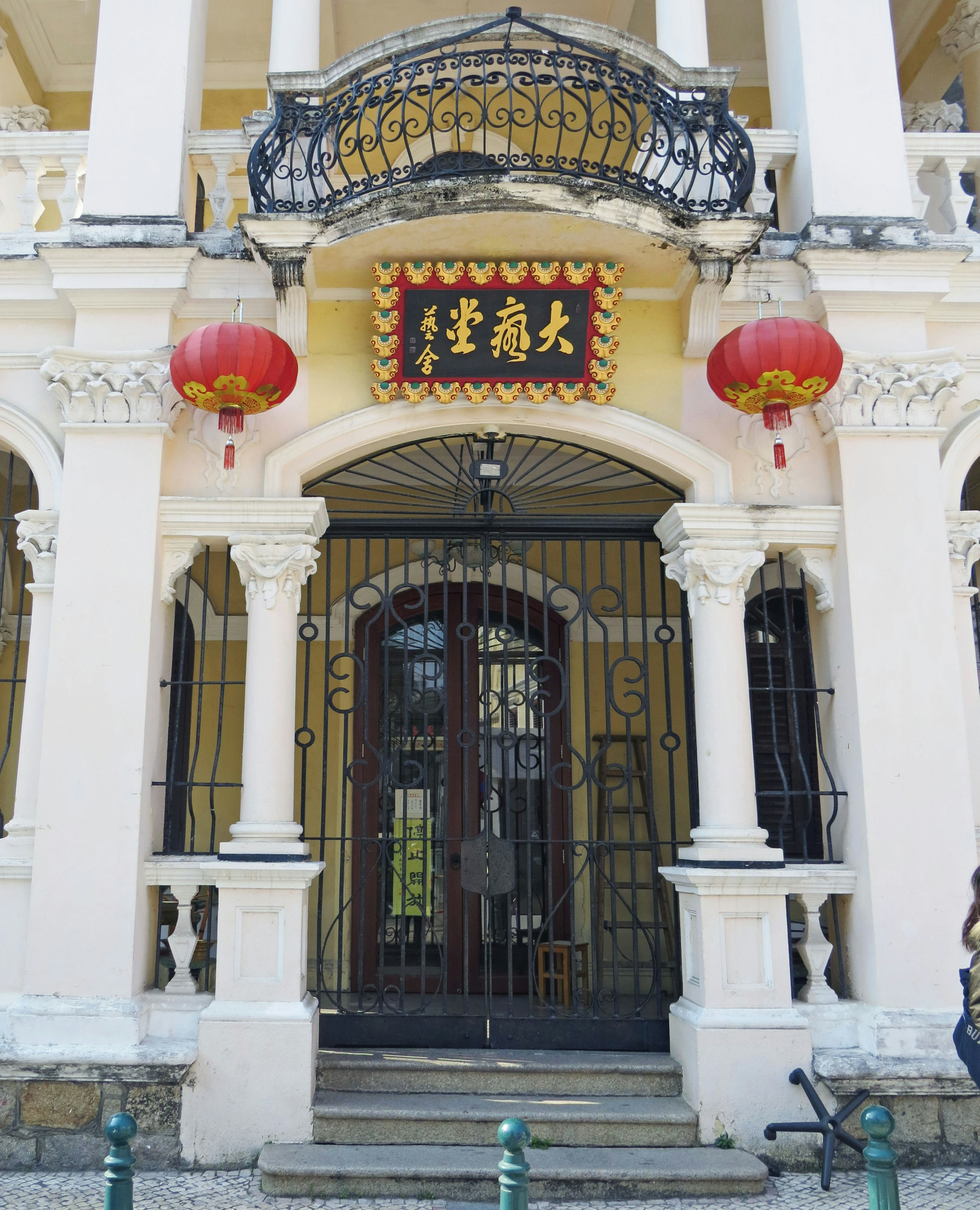 Historic building entrance with decorative lanterns and wrought iron details