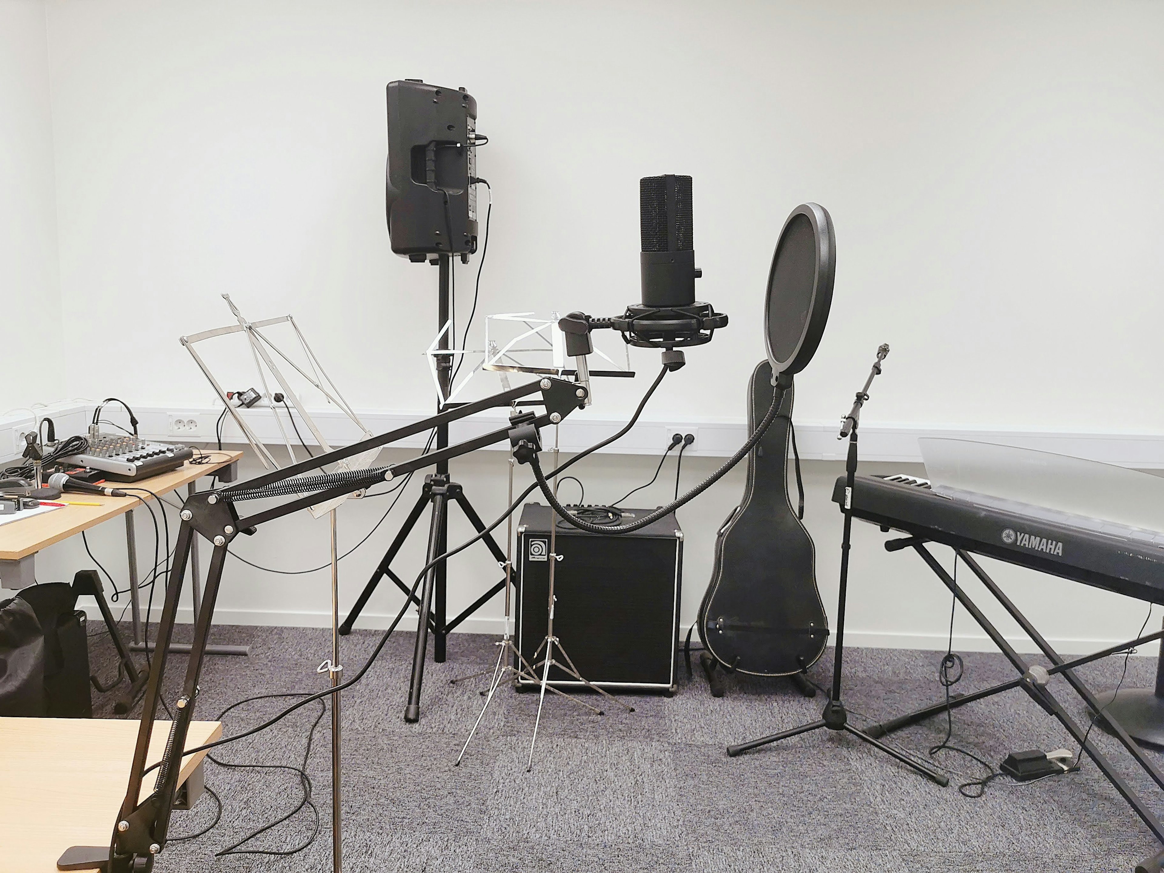 Music equipment arranged in a studio space featuring microphones and speakers