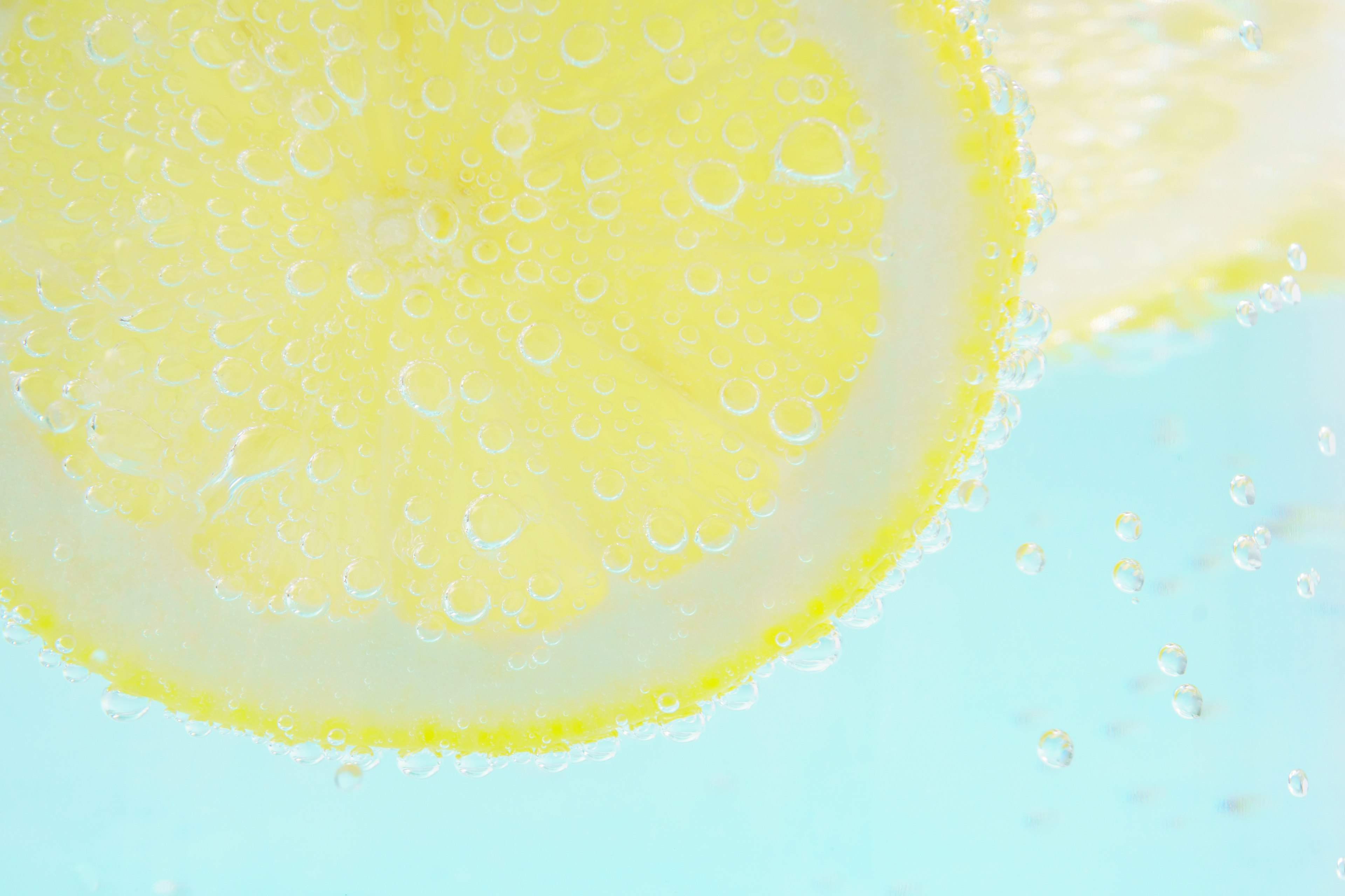 Vibrant image of a lemon slice floating on a blue background