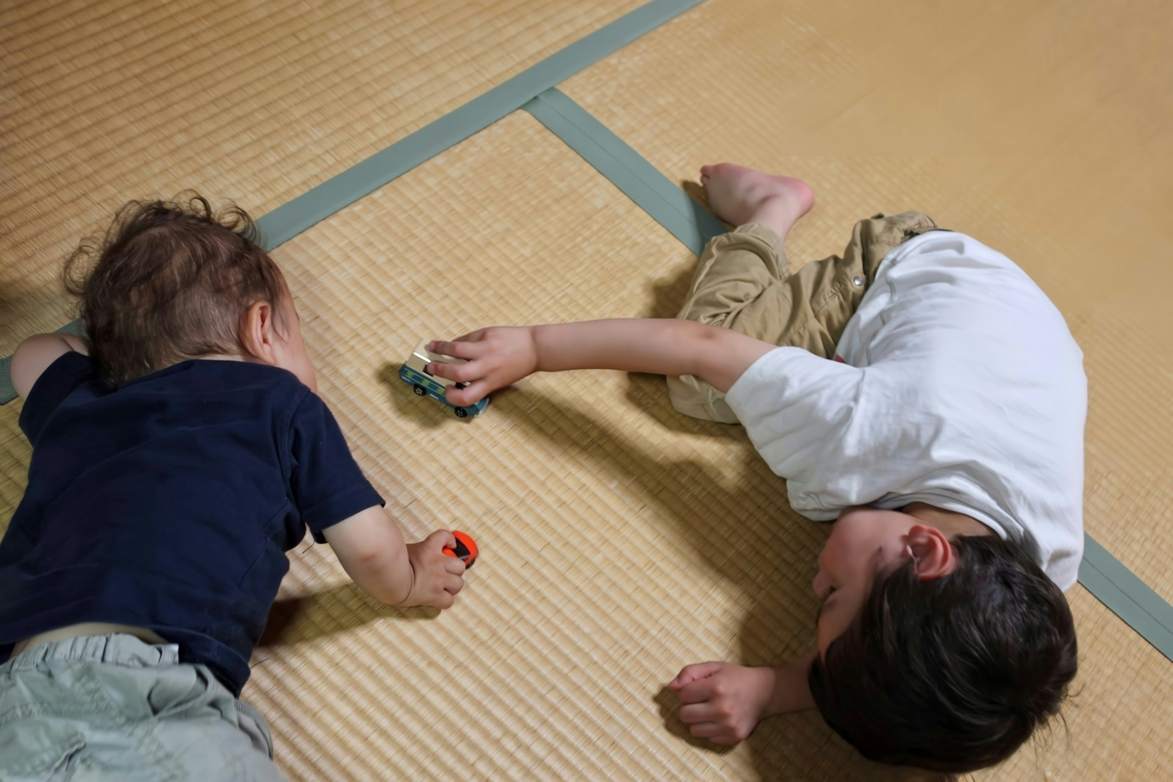 Two children playing on tatami mats