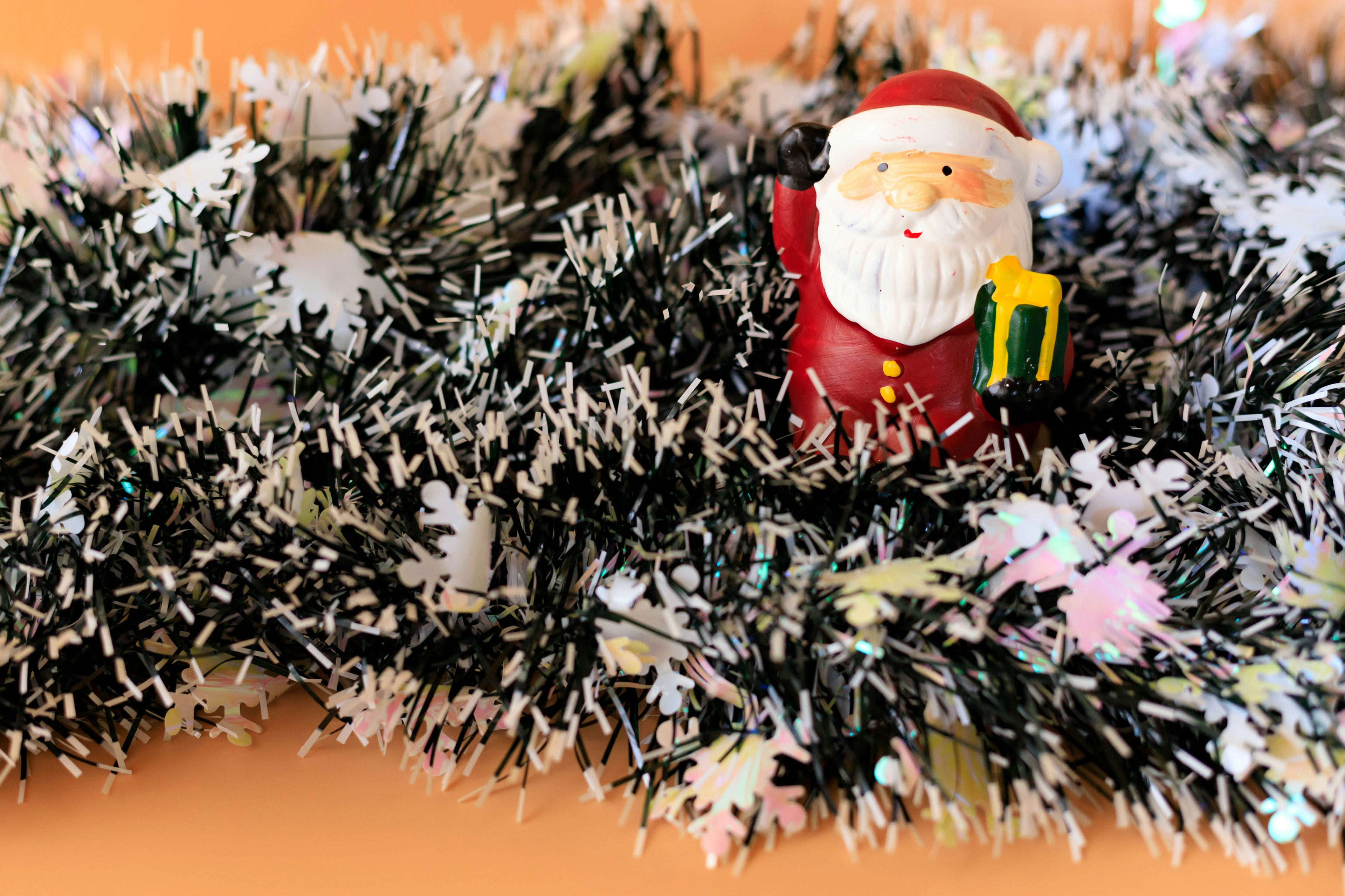 Santa figure nestled in black and white Christmas garland